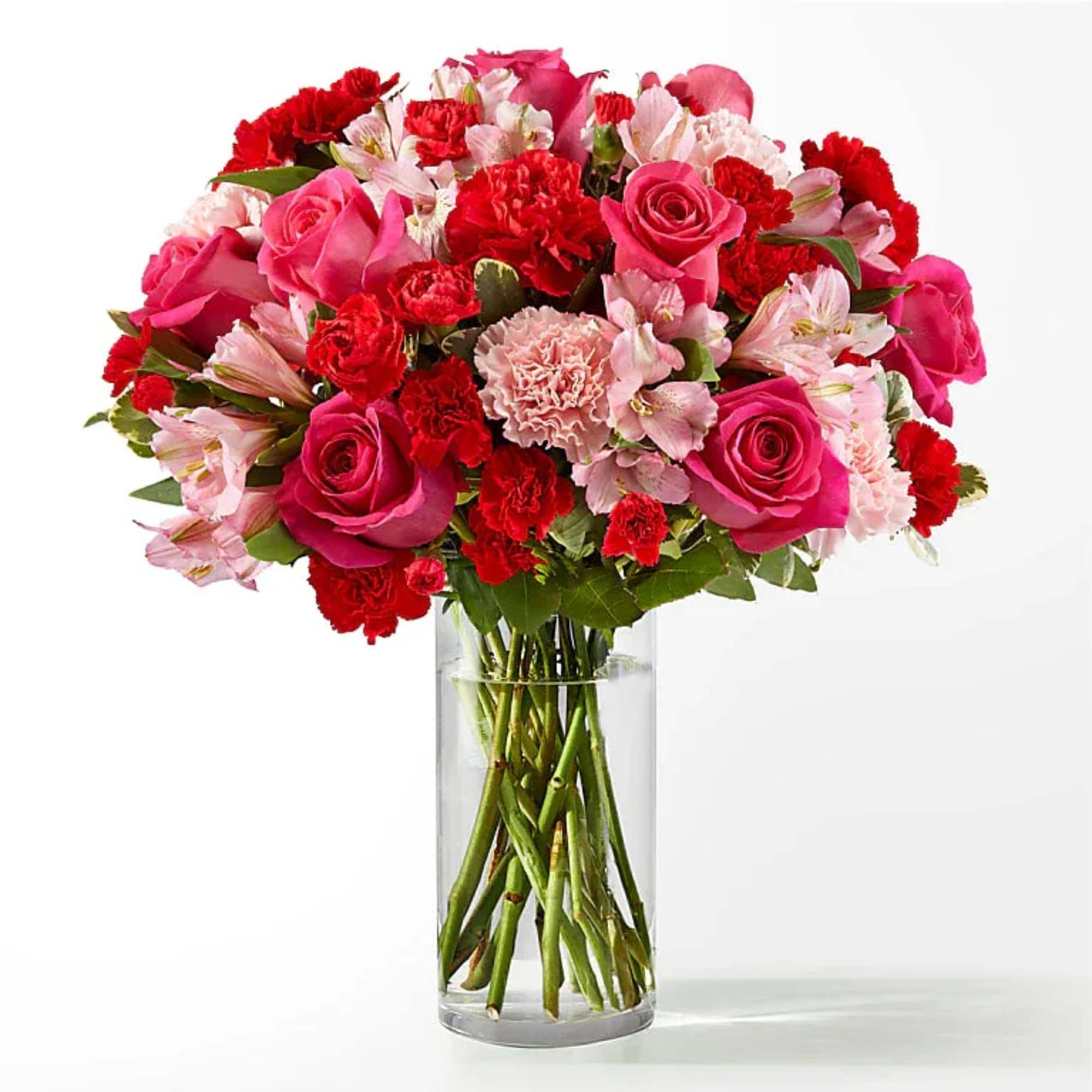 Bouquet of pink and red flowers in a clear glass vase