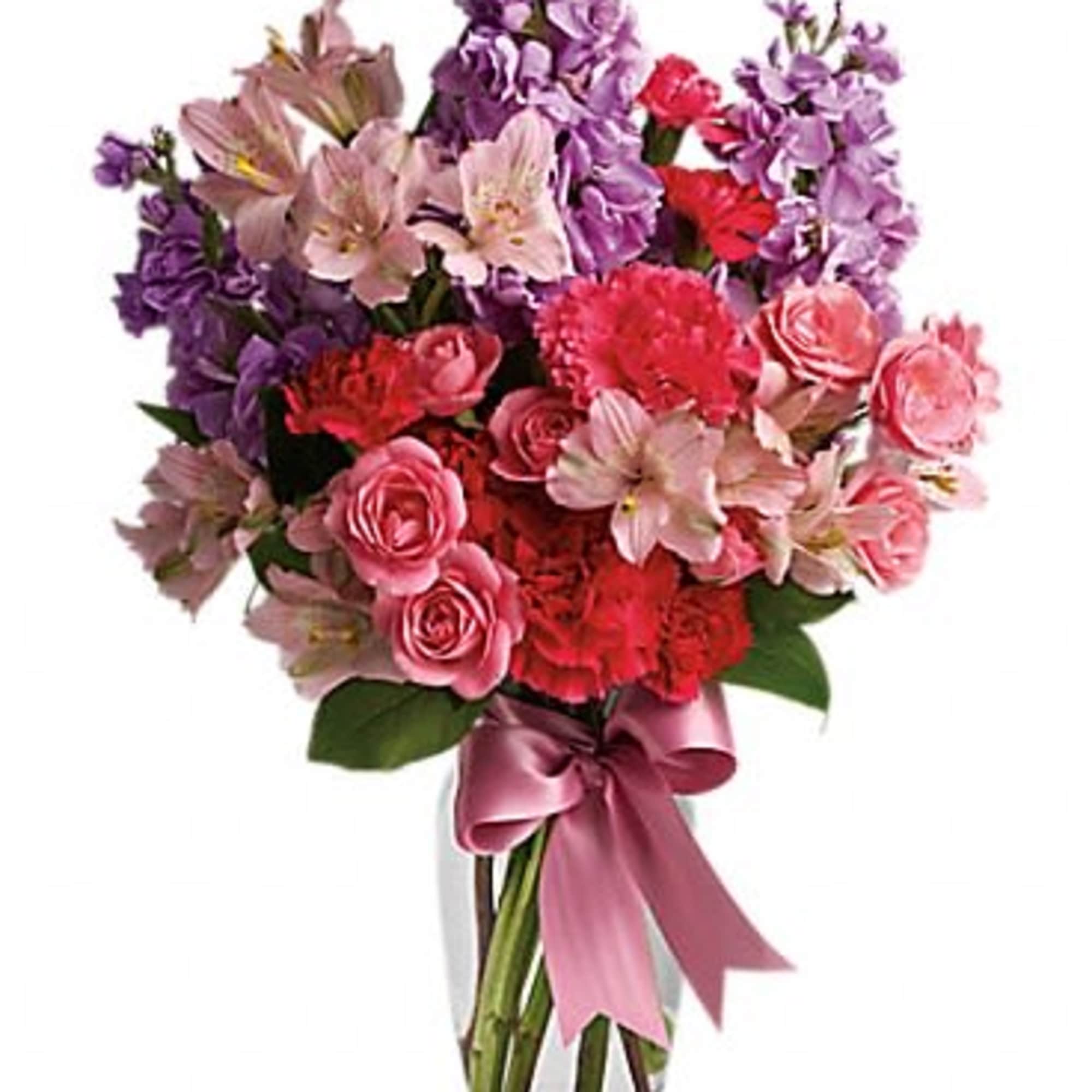 Pink and purple mixed bouquet in a clear glass vase with a ribbon