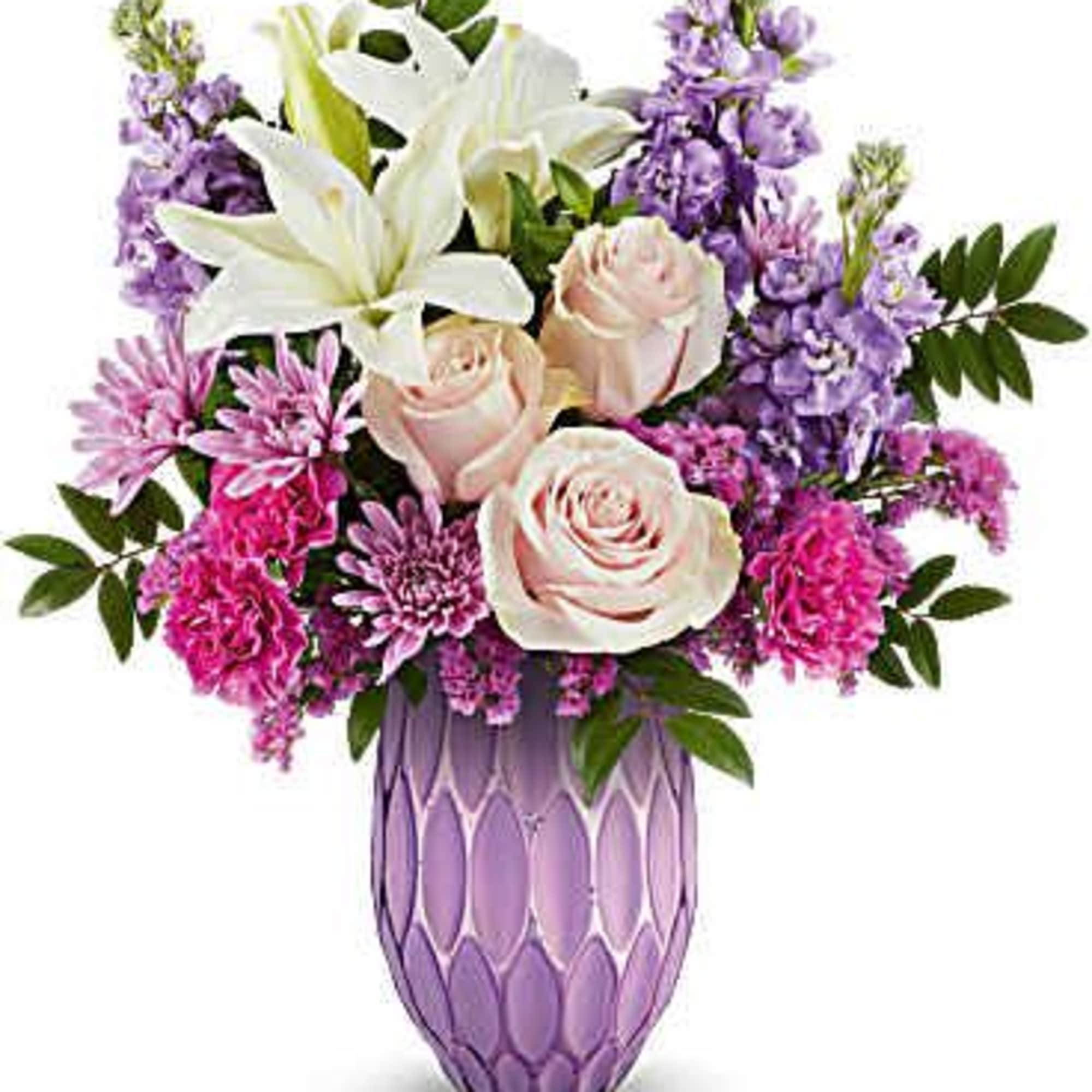 Bouquet of white lilies, pale roses, and purple flowers in a lavender vase