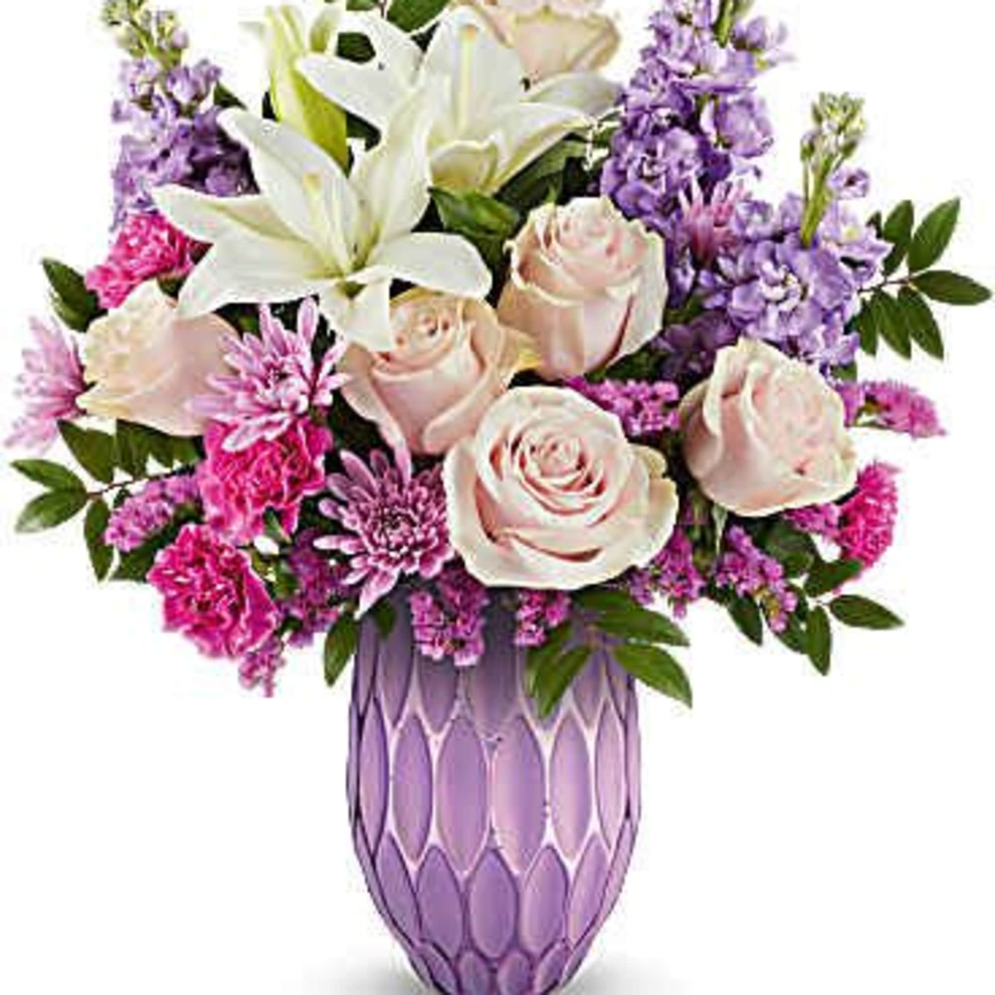 Pink roses and white lilies in a purple glass vase