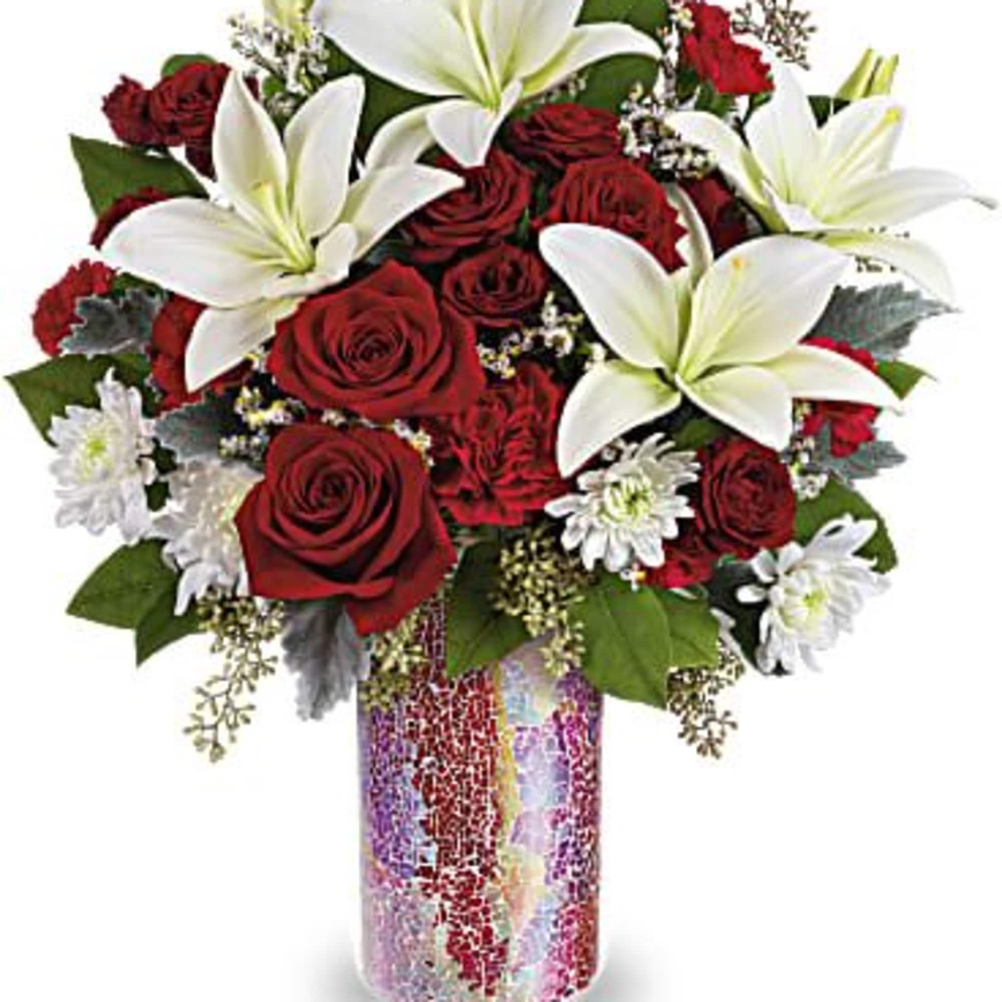 Red roses and white lilies in a colorful glass vase
