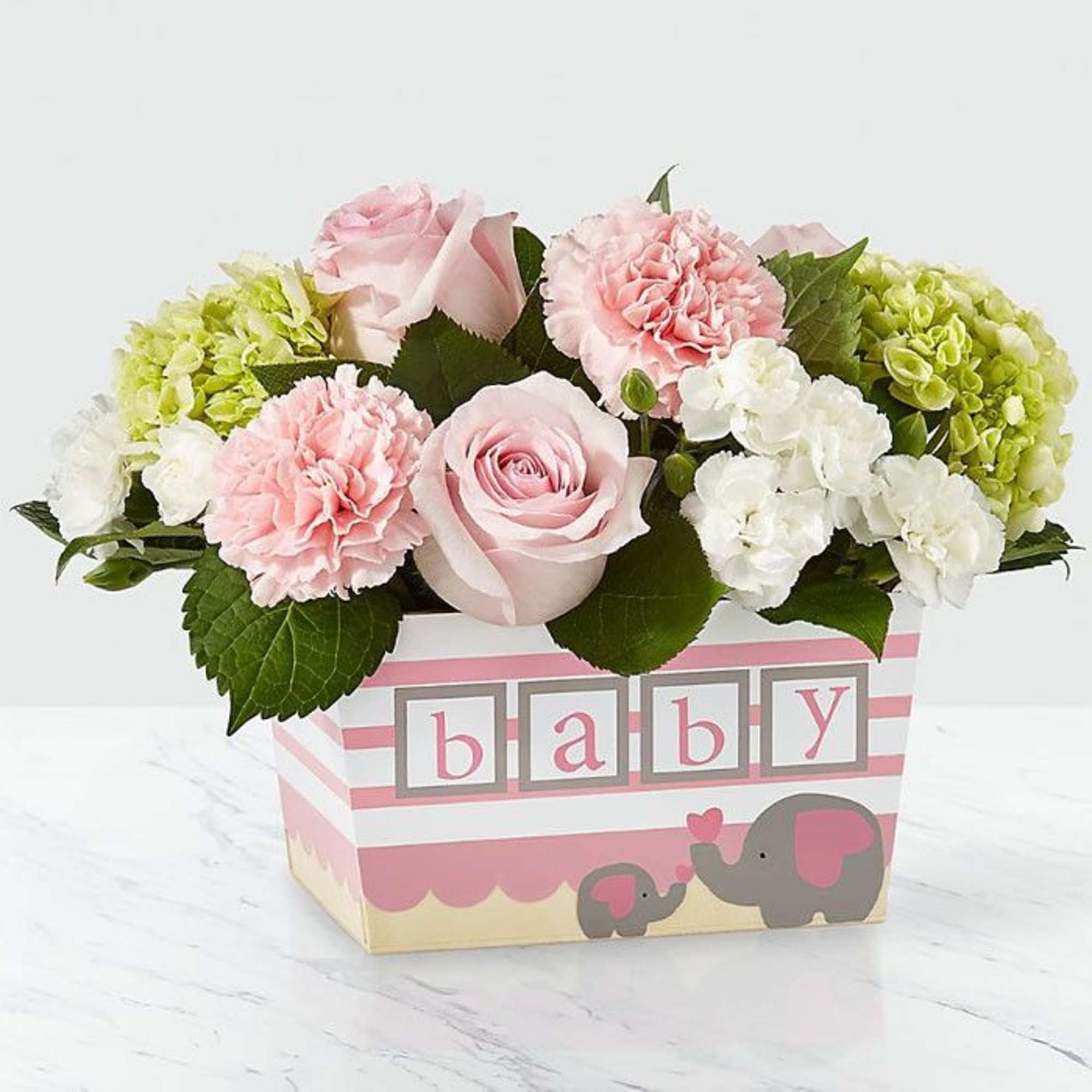 Pink roses and soft carnations mingle with white blooms and lreen mini