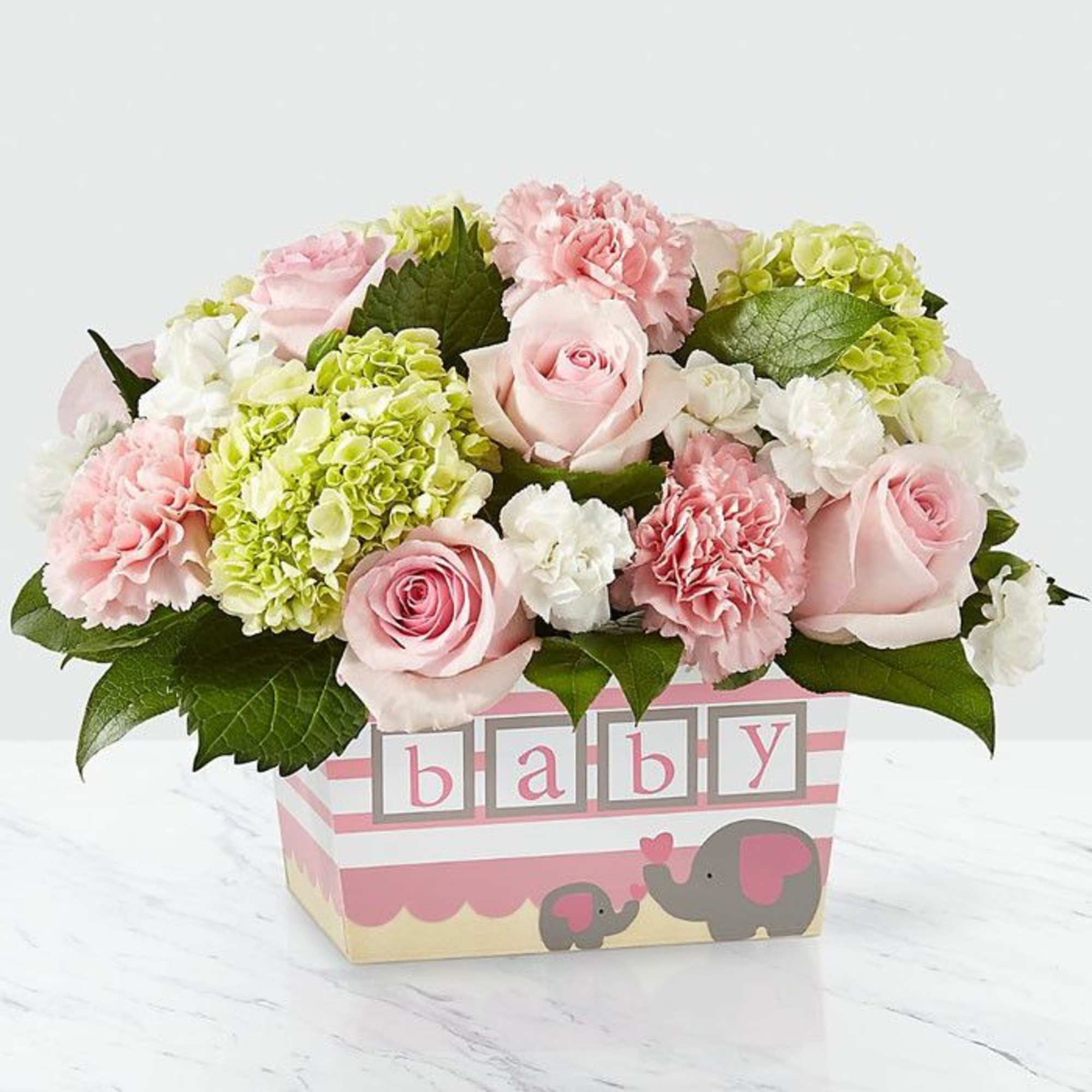 Pink roses and soft carnations mingle with white blooms and lreen mini