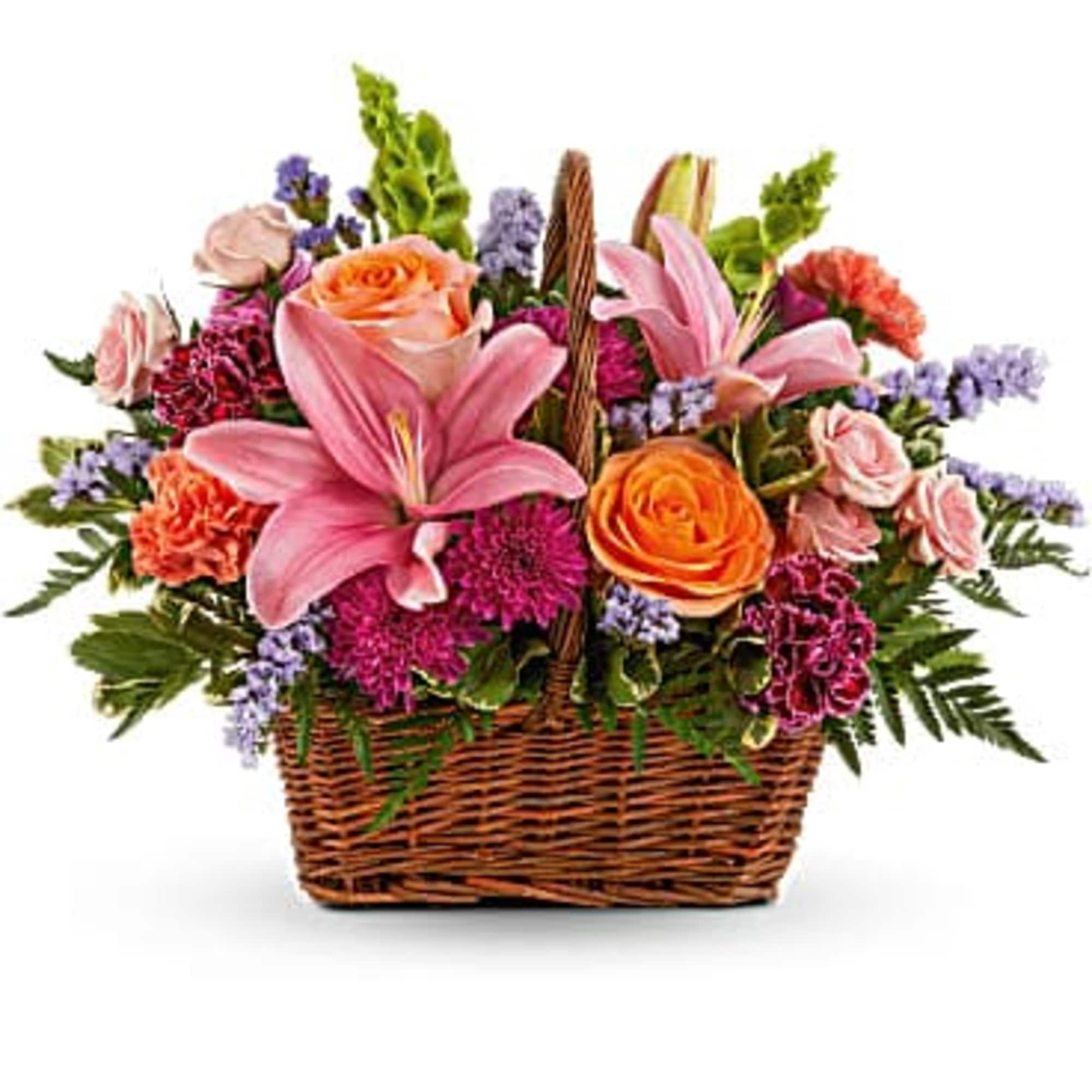 Basket arrangement with pink lilies, orange roses, and purple flowers
