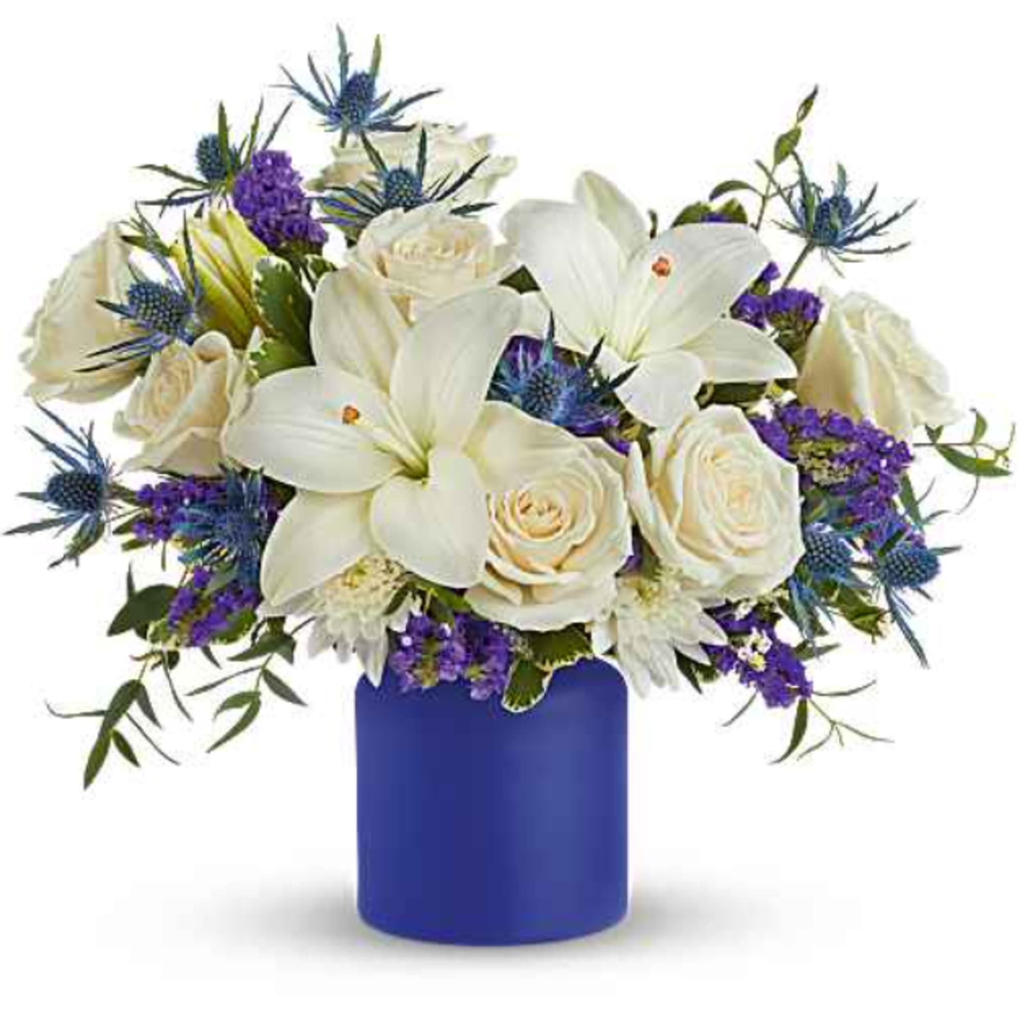 White lilies and roses in a blue vase with purple accents