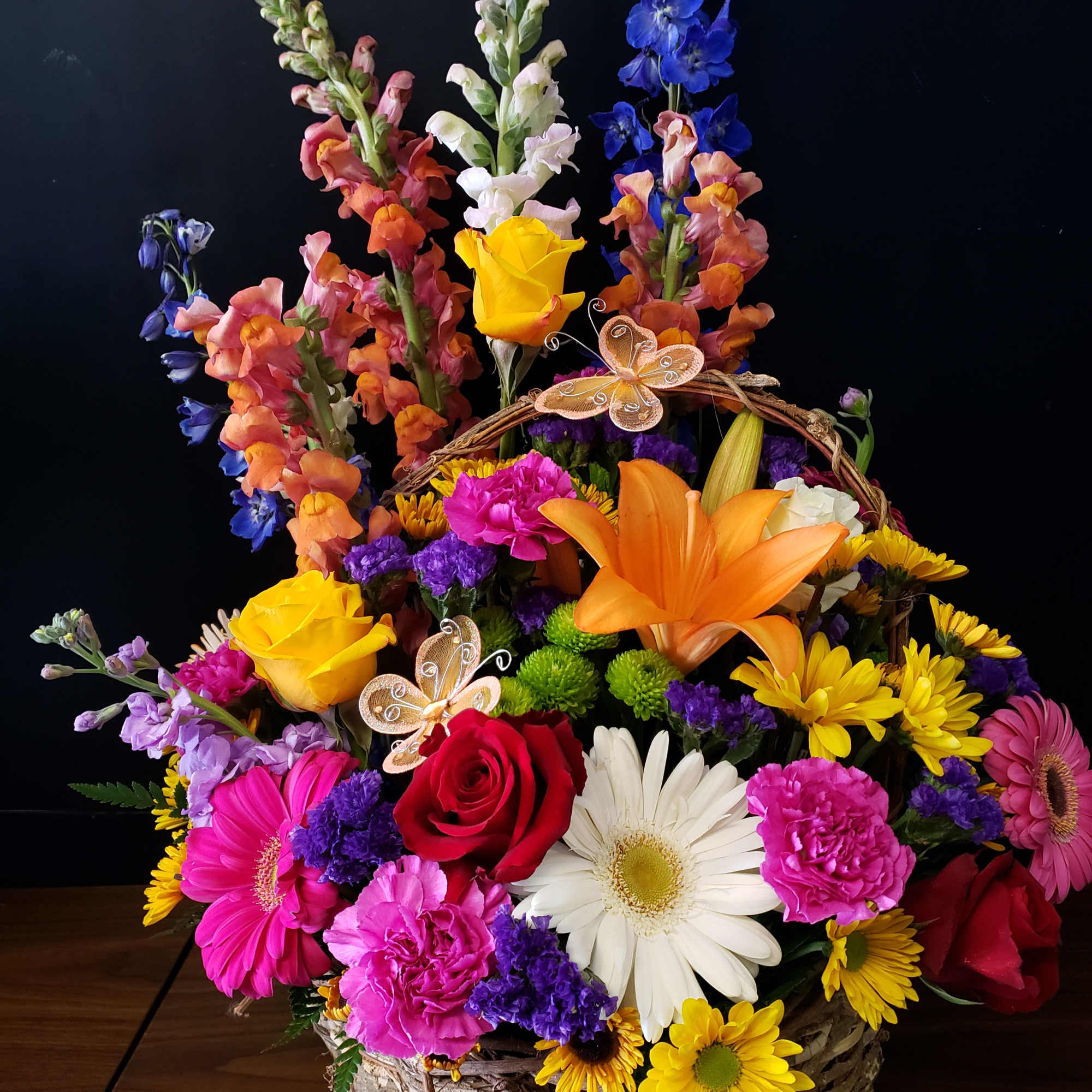 Bright, garden-fresh color takes center stage in this cheerful basket arrangement-perfect as