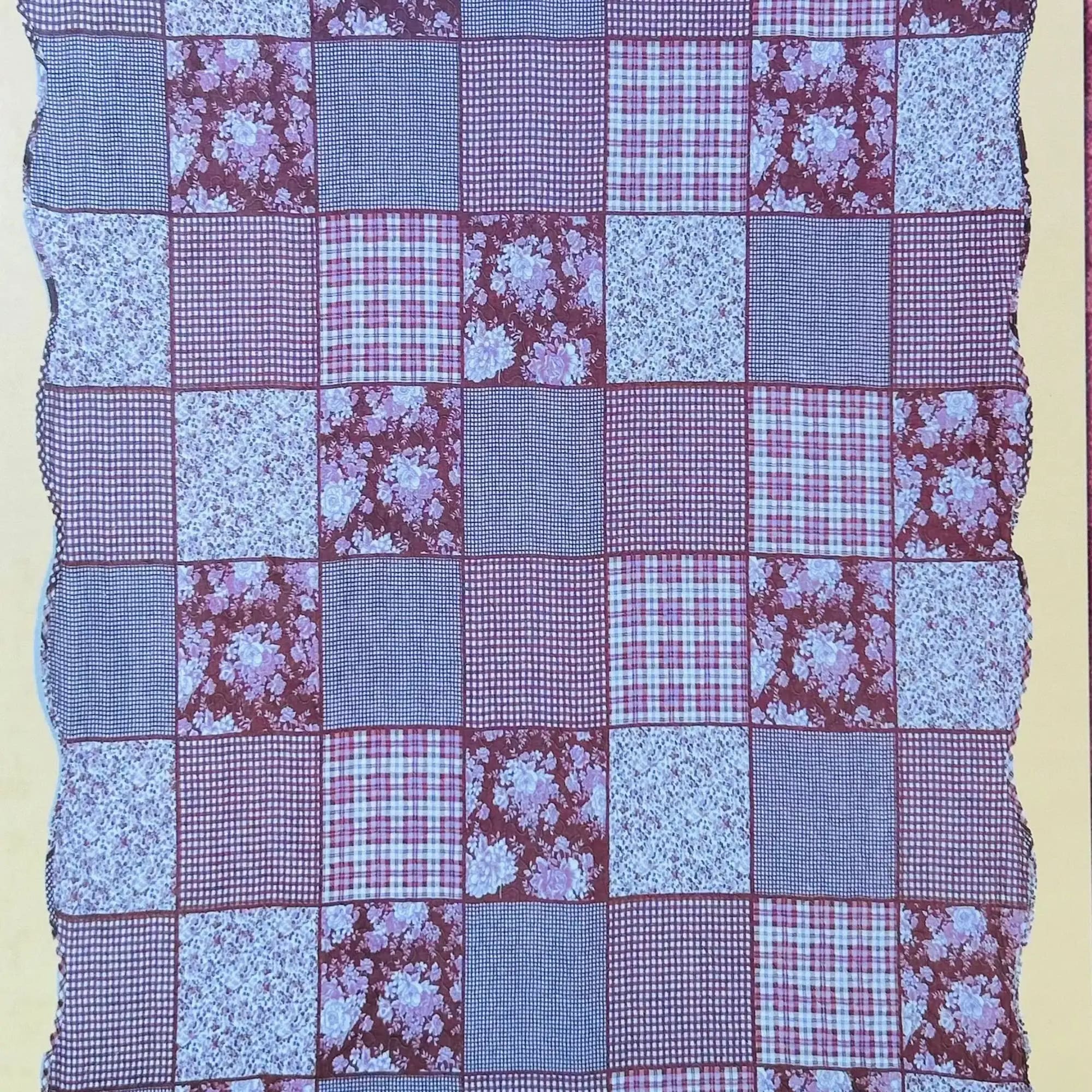 Patchwork quilt with red, blue, and floral fabric squares