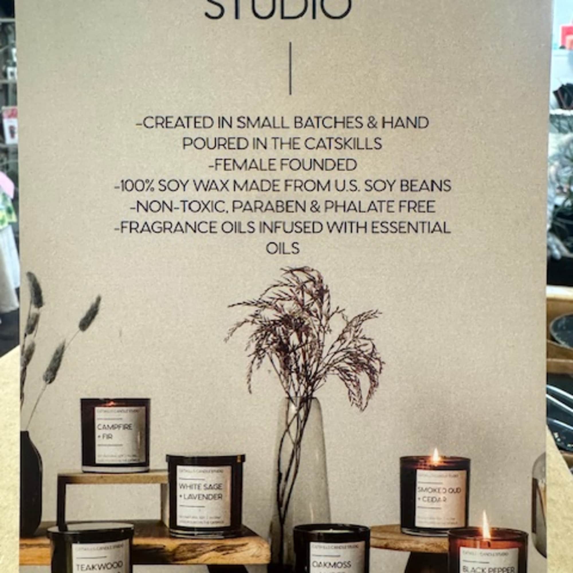 Display of Catskills Candle Studio candles with dried stems in a vase