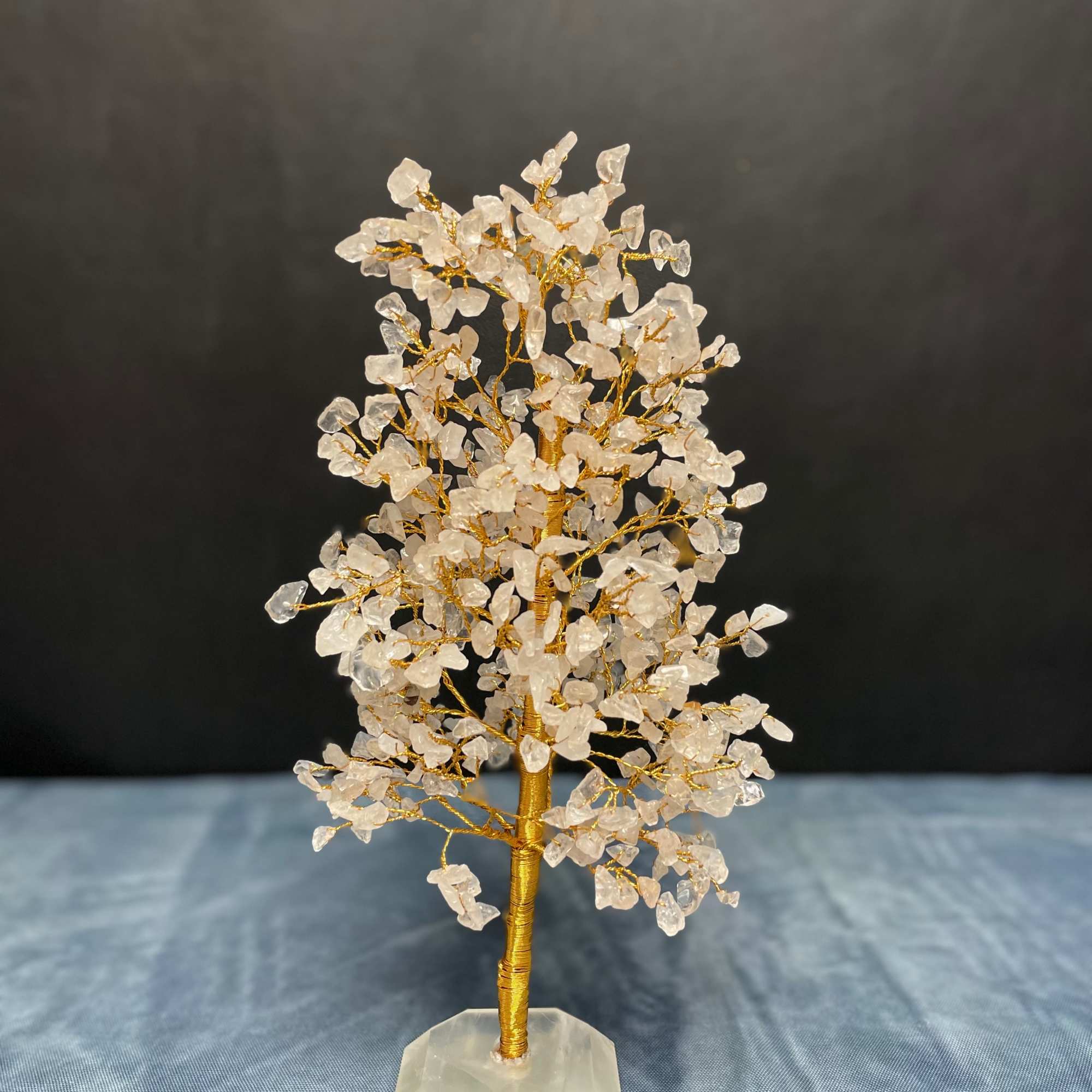 Wire gemstone tree with clear crystal chips on a faceted stone base