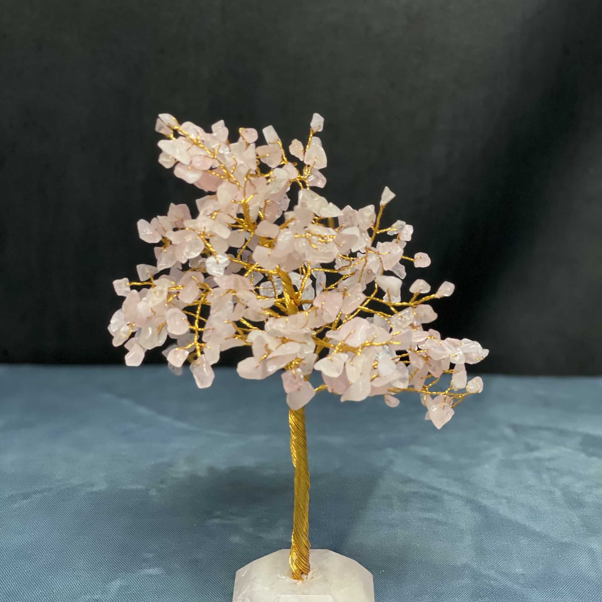 Small crystal tree with pale pink stones on a white base