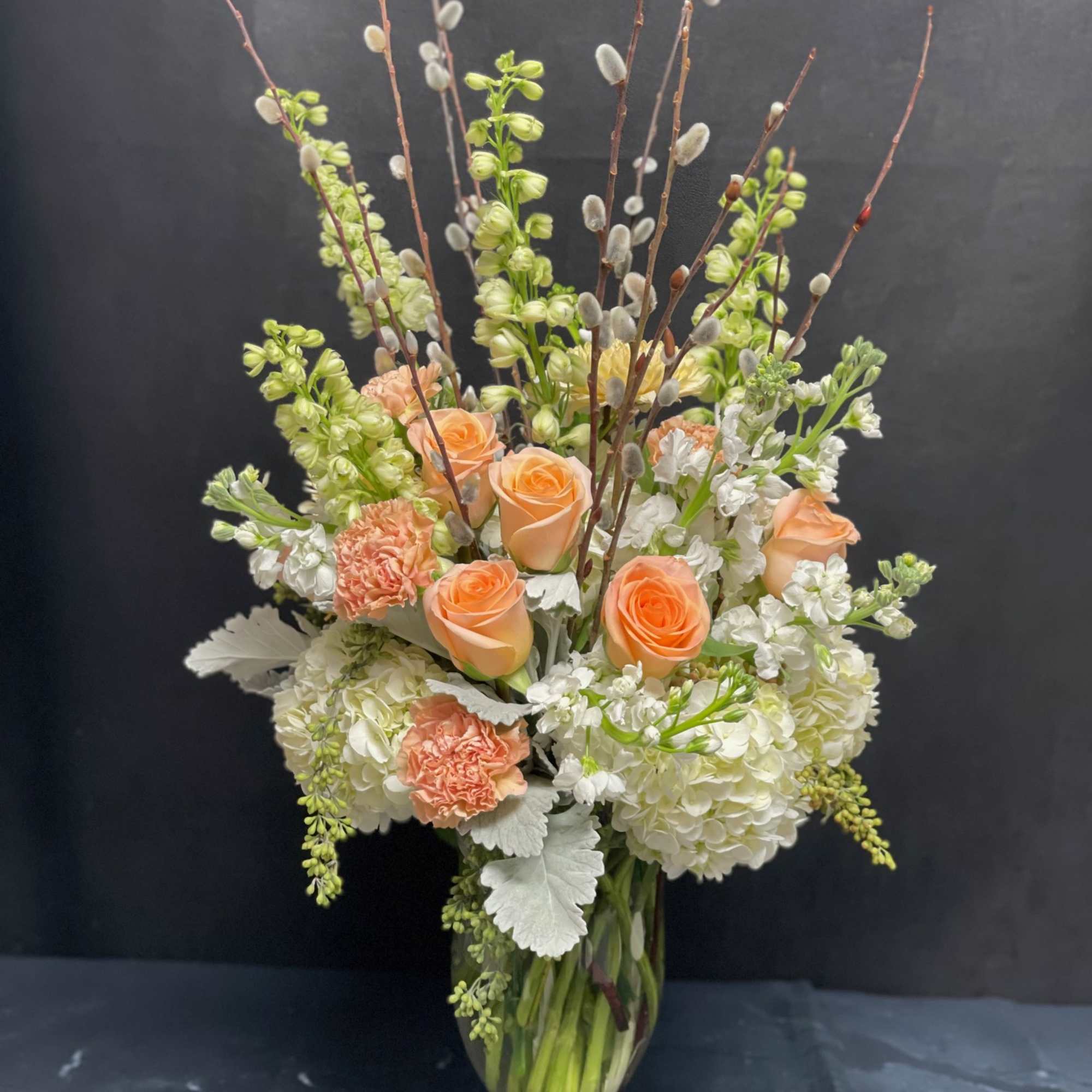 White Hydrangeas, Peach Roses, Peach Carnations, White Stocks, White Delphiniums, Peach Mums