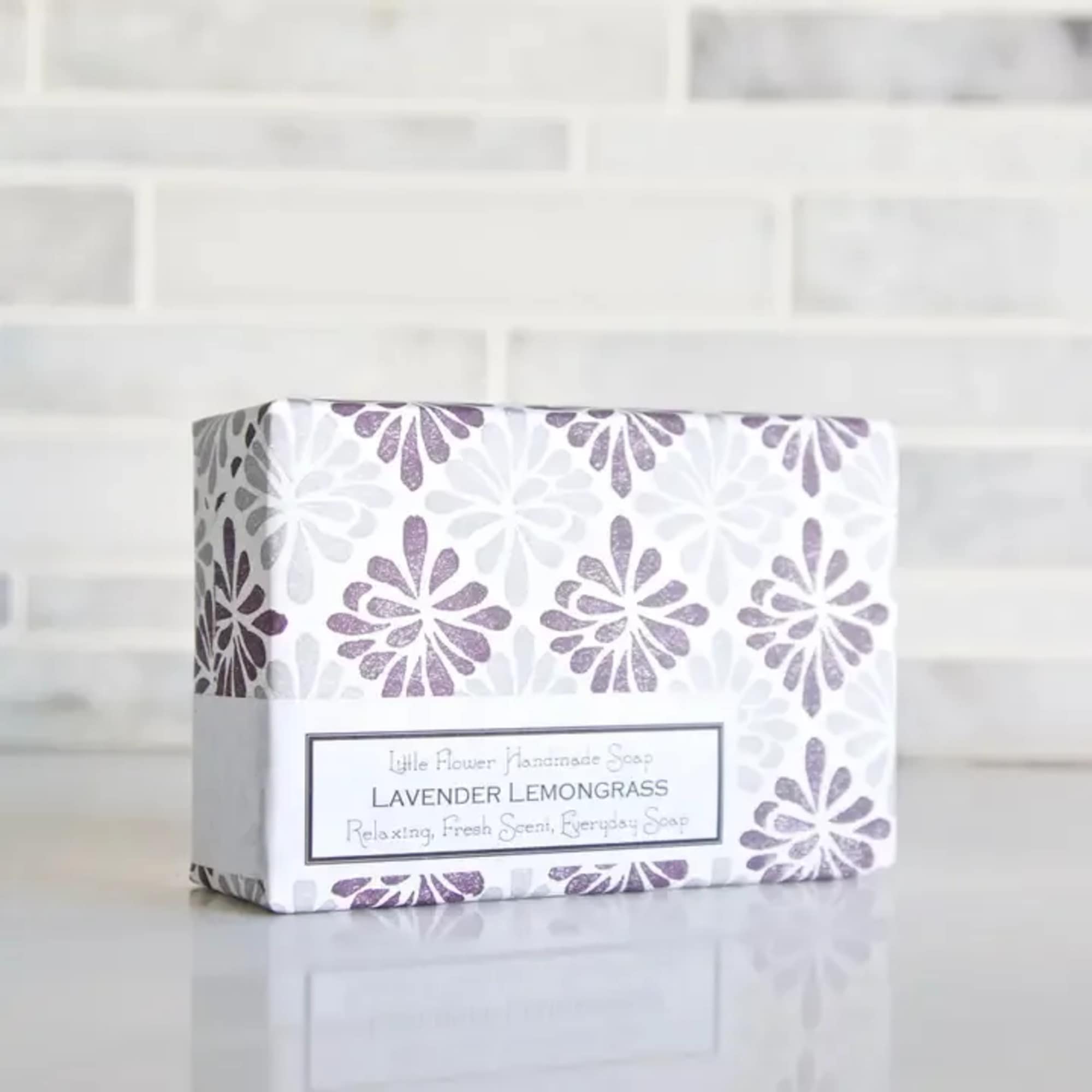 Boxed bar of lavender lemongrass soap with purple floral pattern on white wrapper