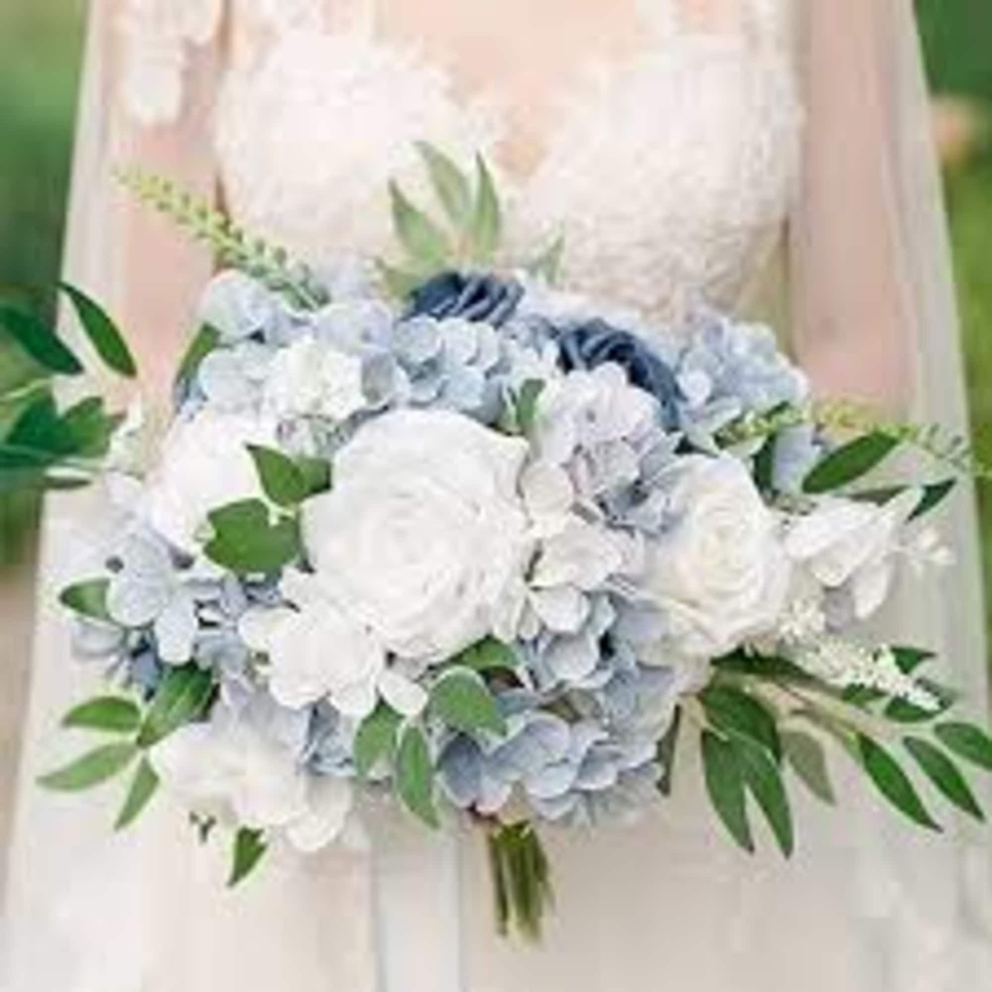 White and pale blue bridal bouquet with greenery