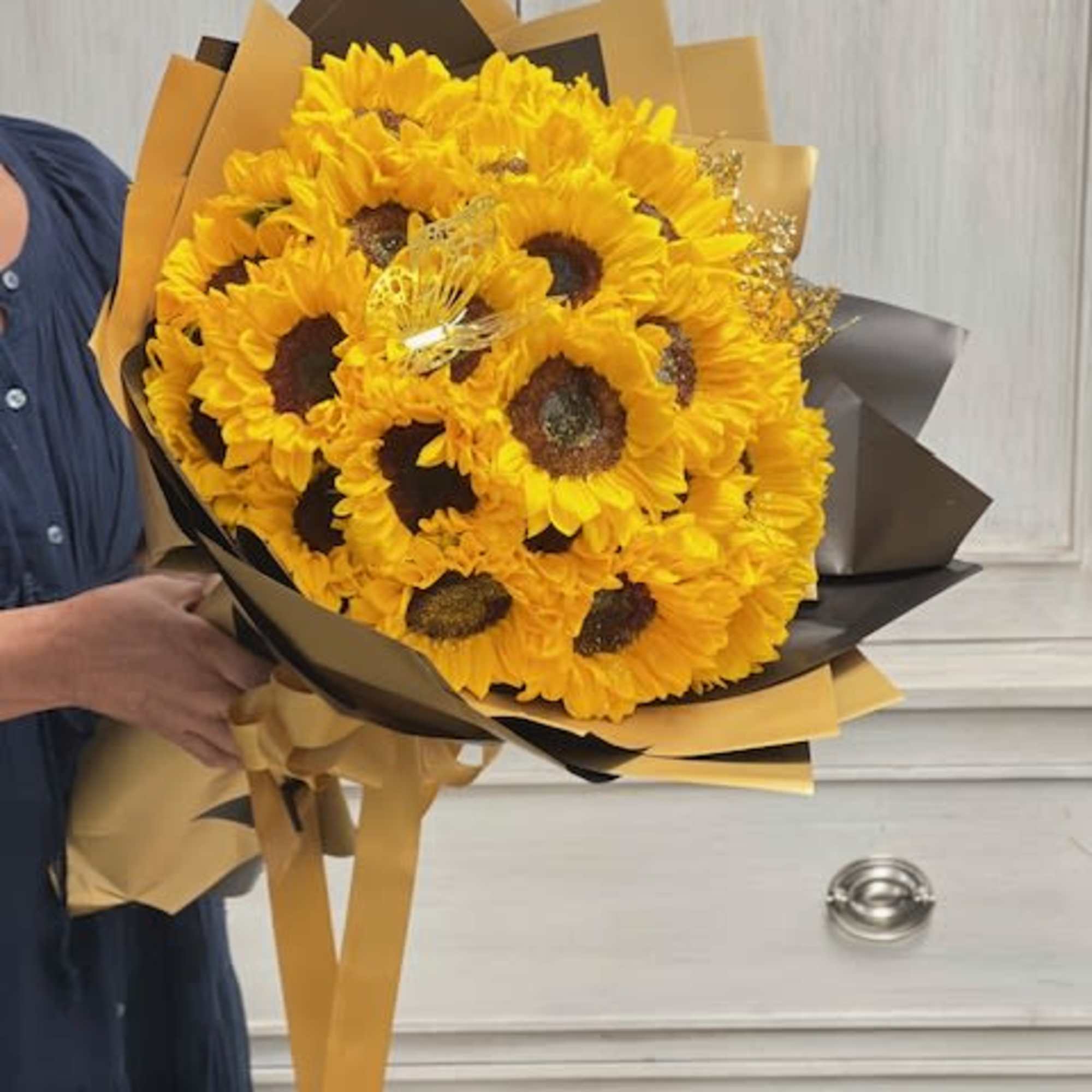 Bouquet of bright yellow sunflowers wrapped in black and gold paper, photo 2 of 2