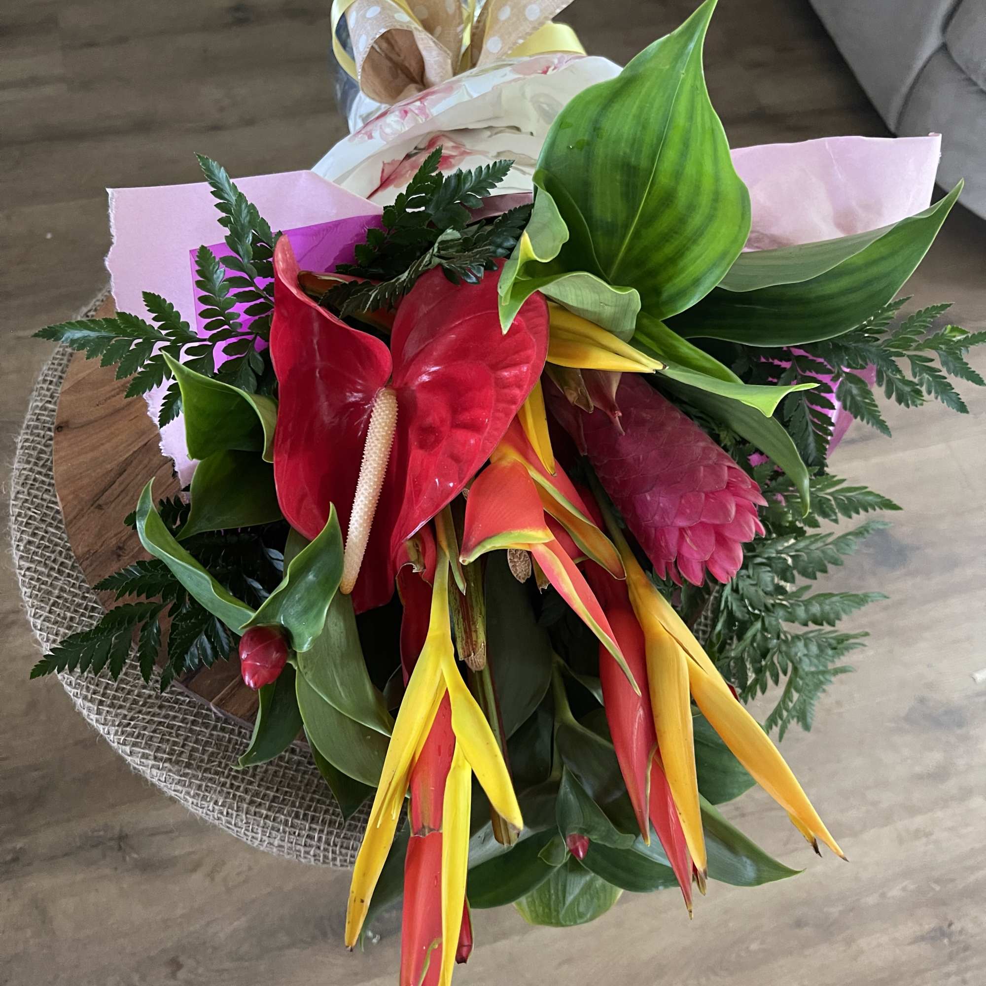 Tropical bouquet with red anthuriums and yellow-red heliconia