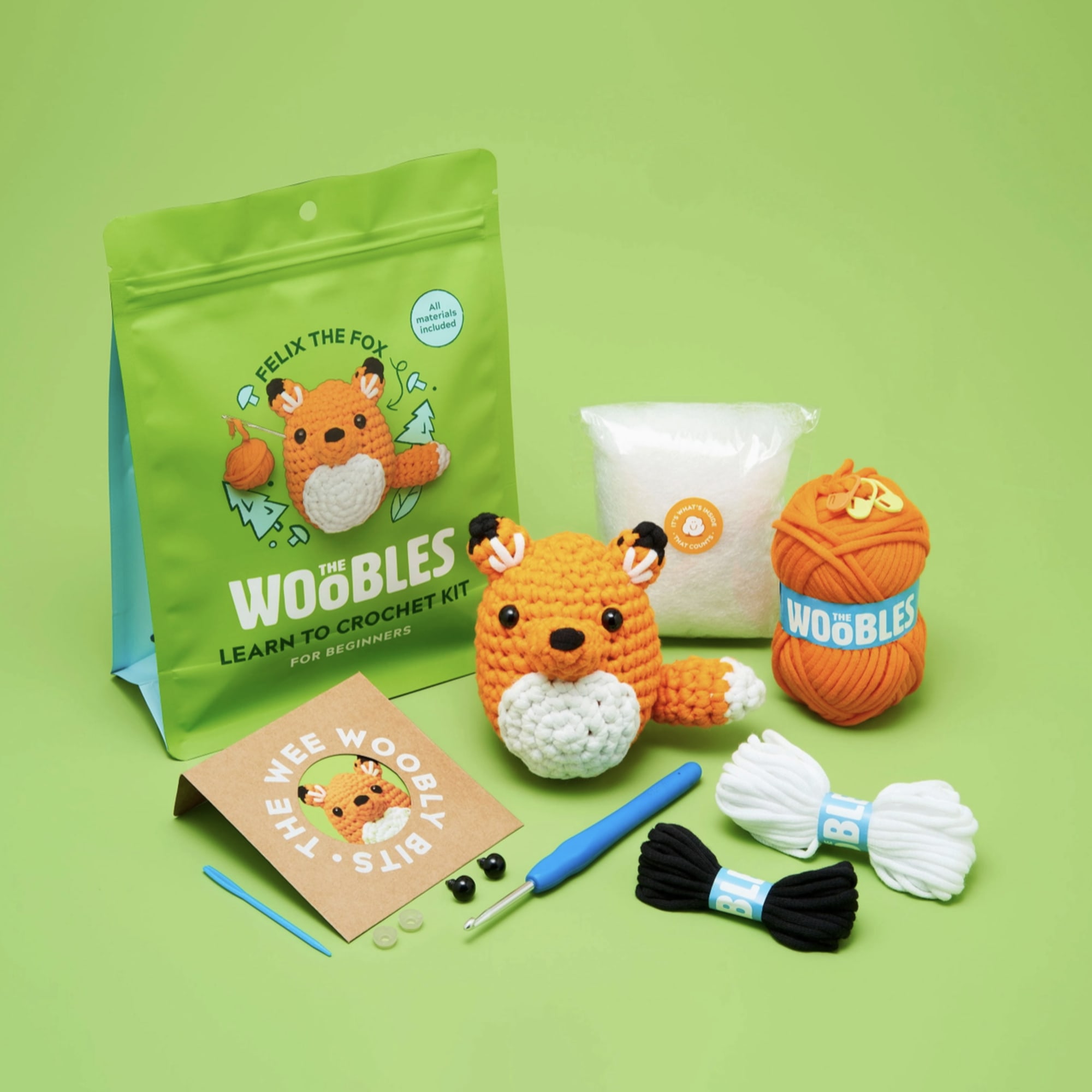 Crochet kit with fox figure, yarn, hook, and instructions
