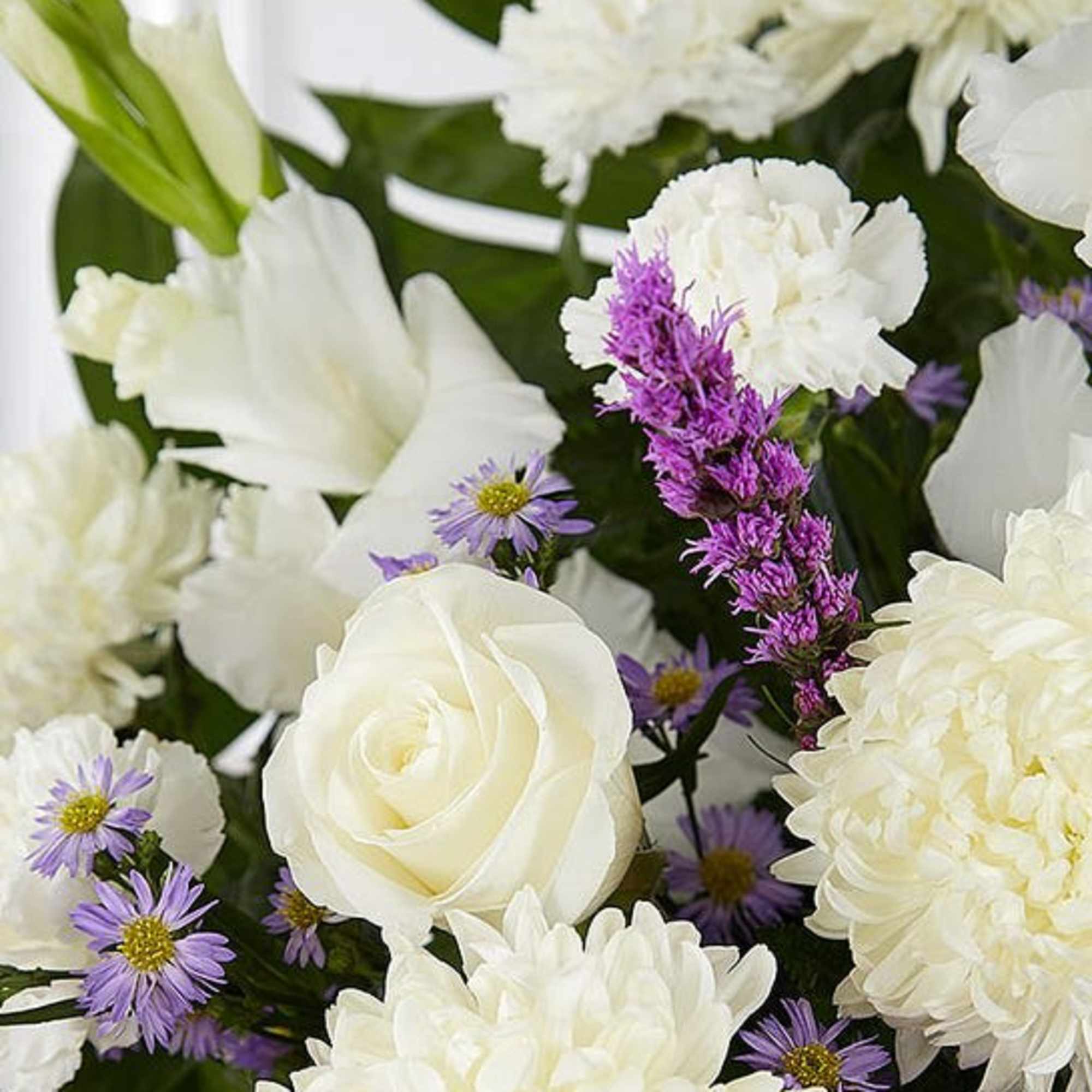White roses and chrysanthemums with small purple daisies