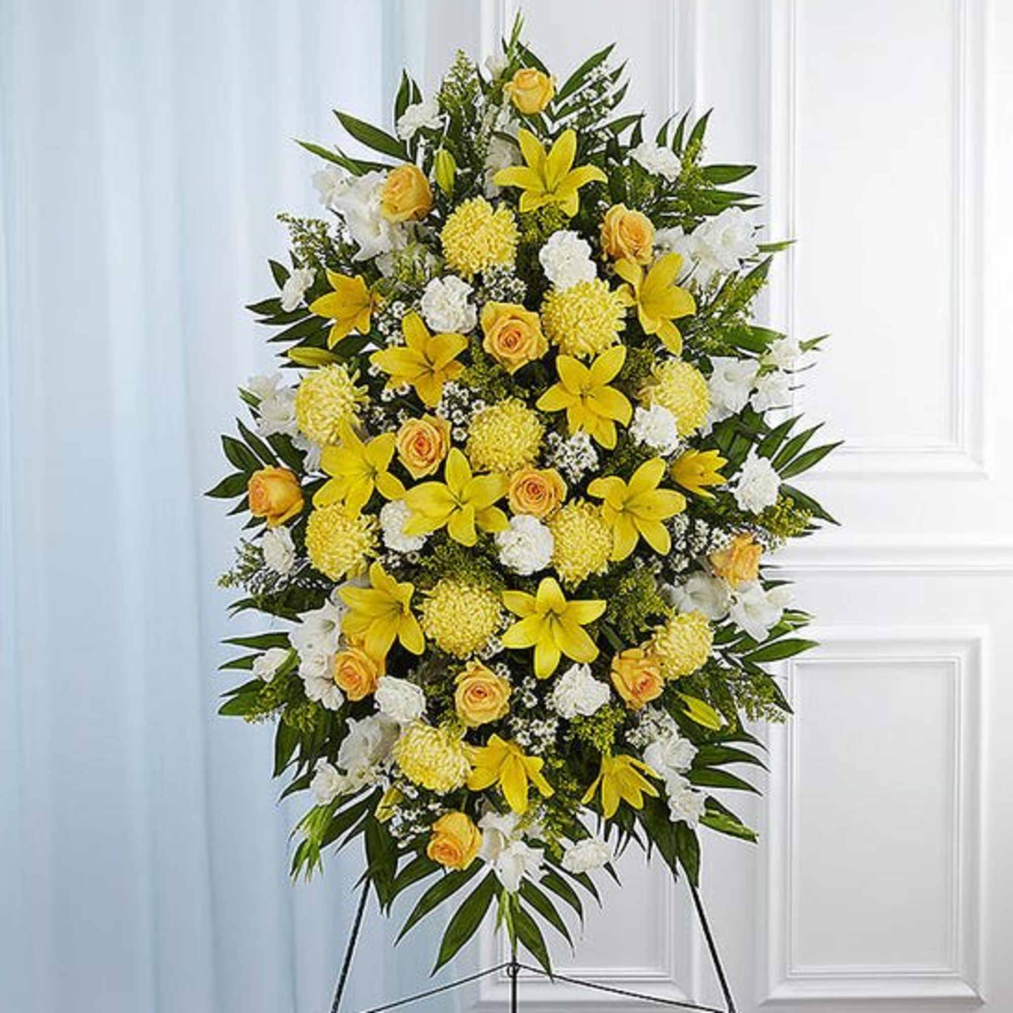Yellow and white floral standing spray on an easel