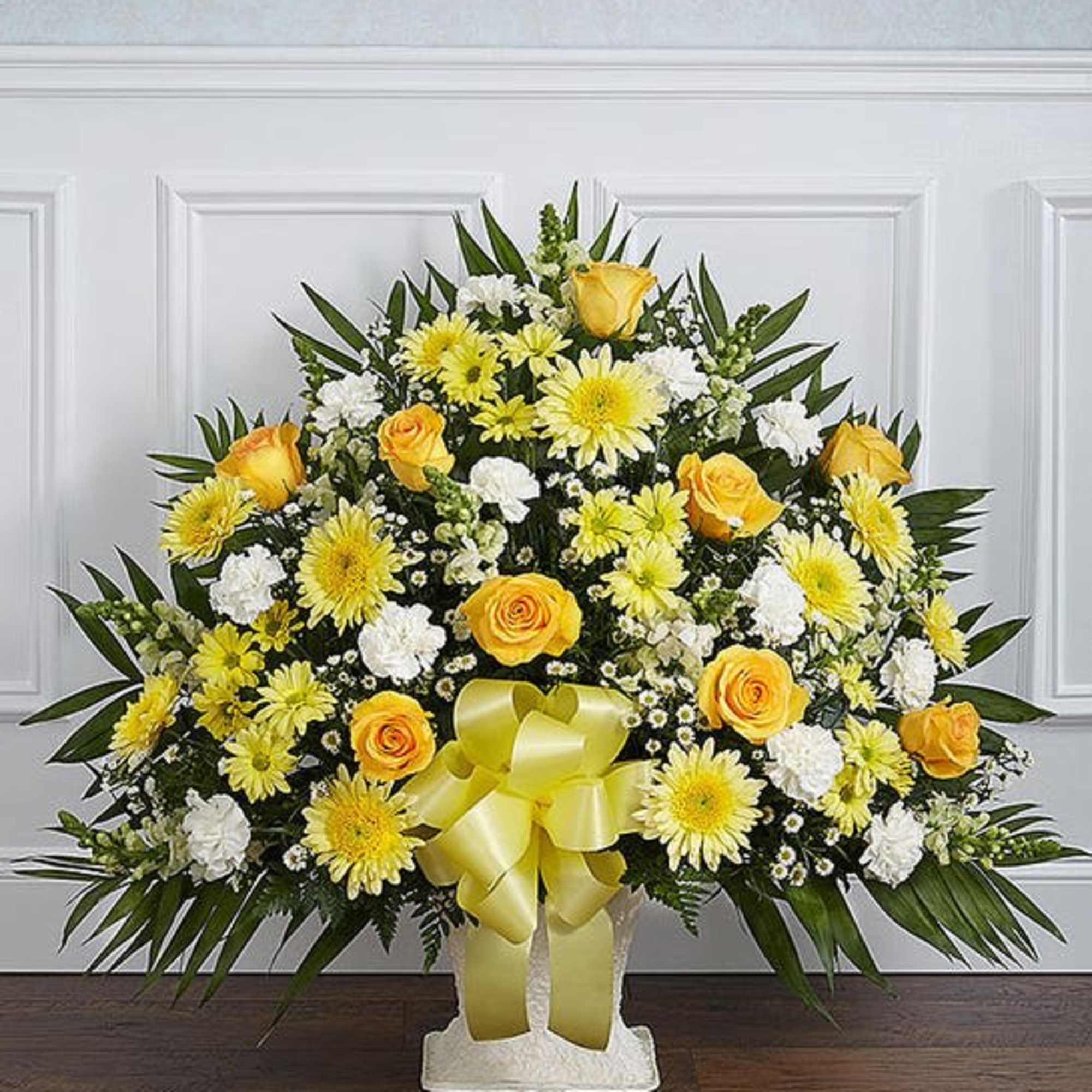 Yellow and white floral standing spray with a ribbon bow