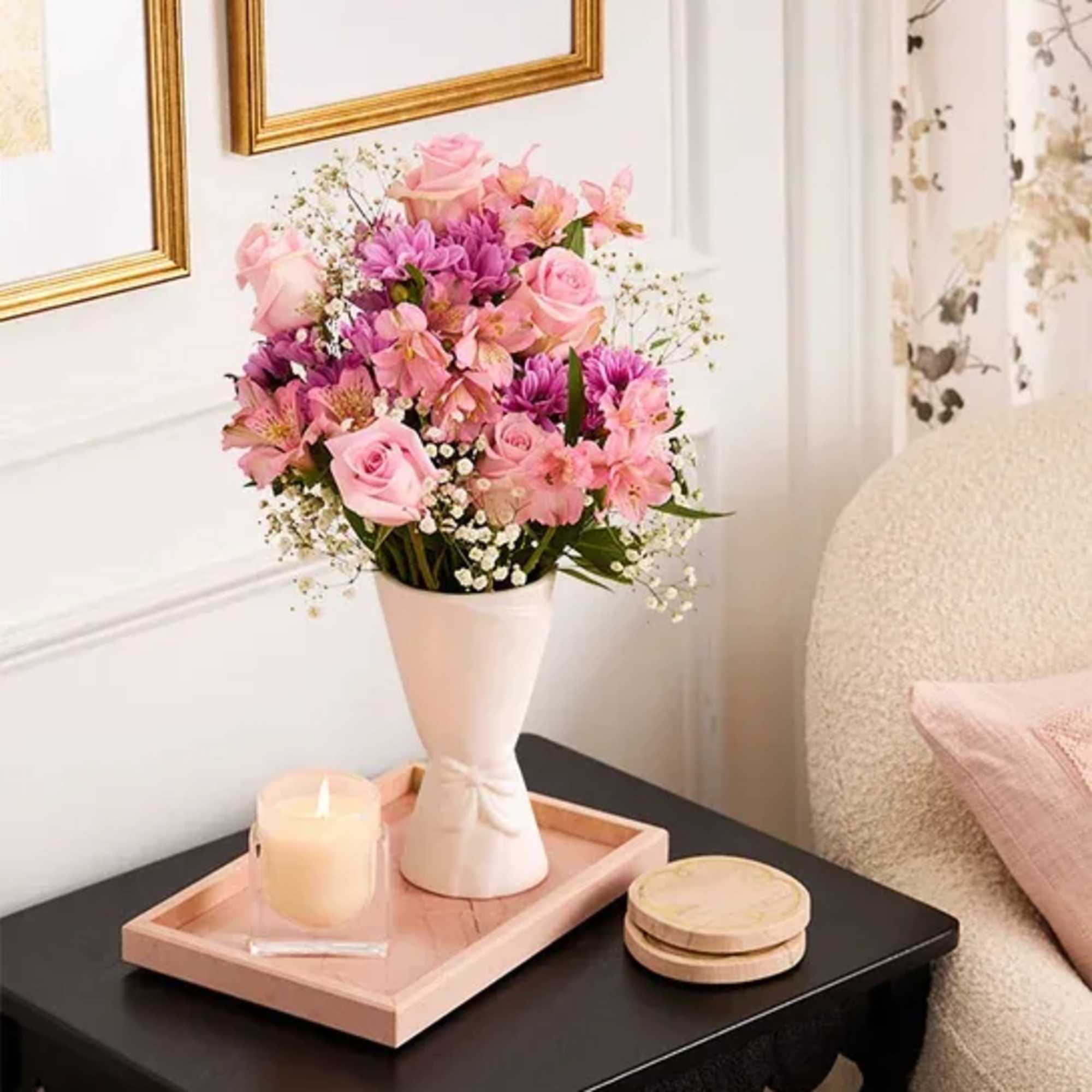 Soft pink roses paired with purple daisy-like blooms and delicate pink alstroemeria