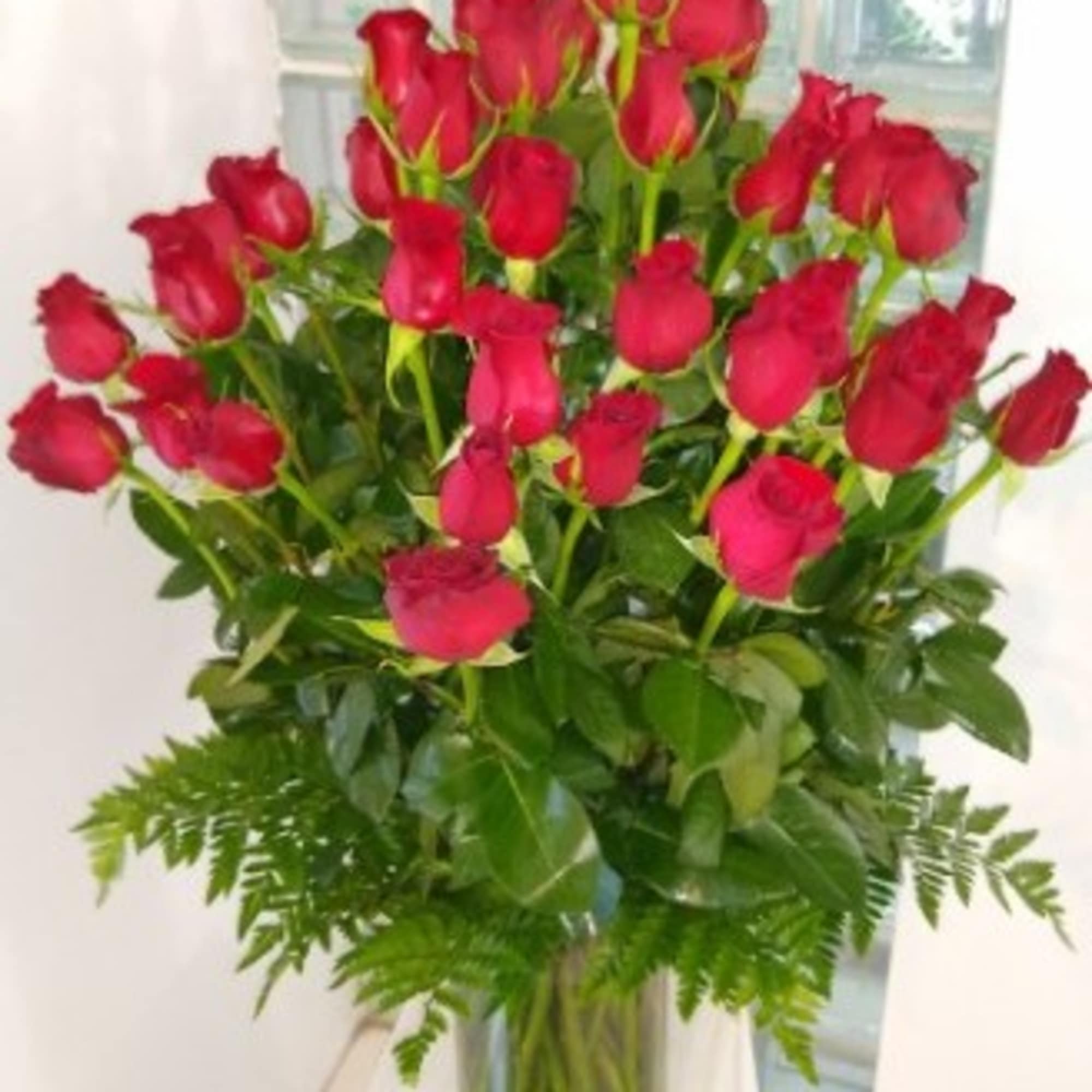 Bouquet of red roses in a glass vase