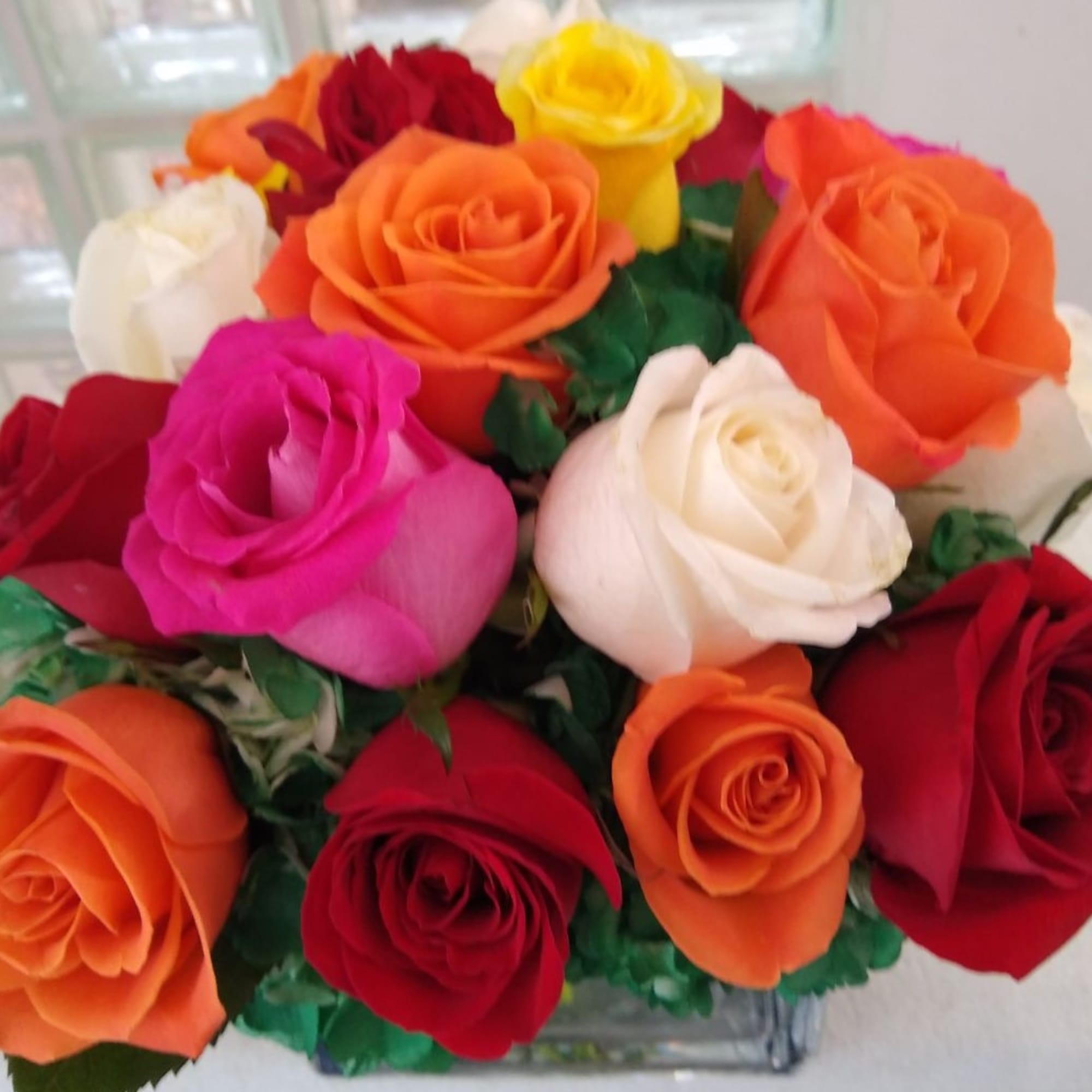 Mixed bouquet of roses in red, orange, pink, yellow, and white