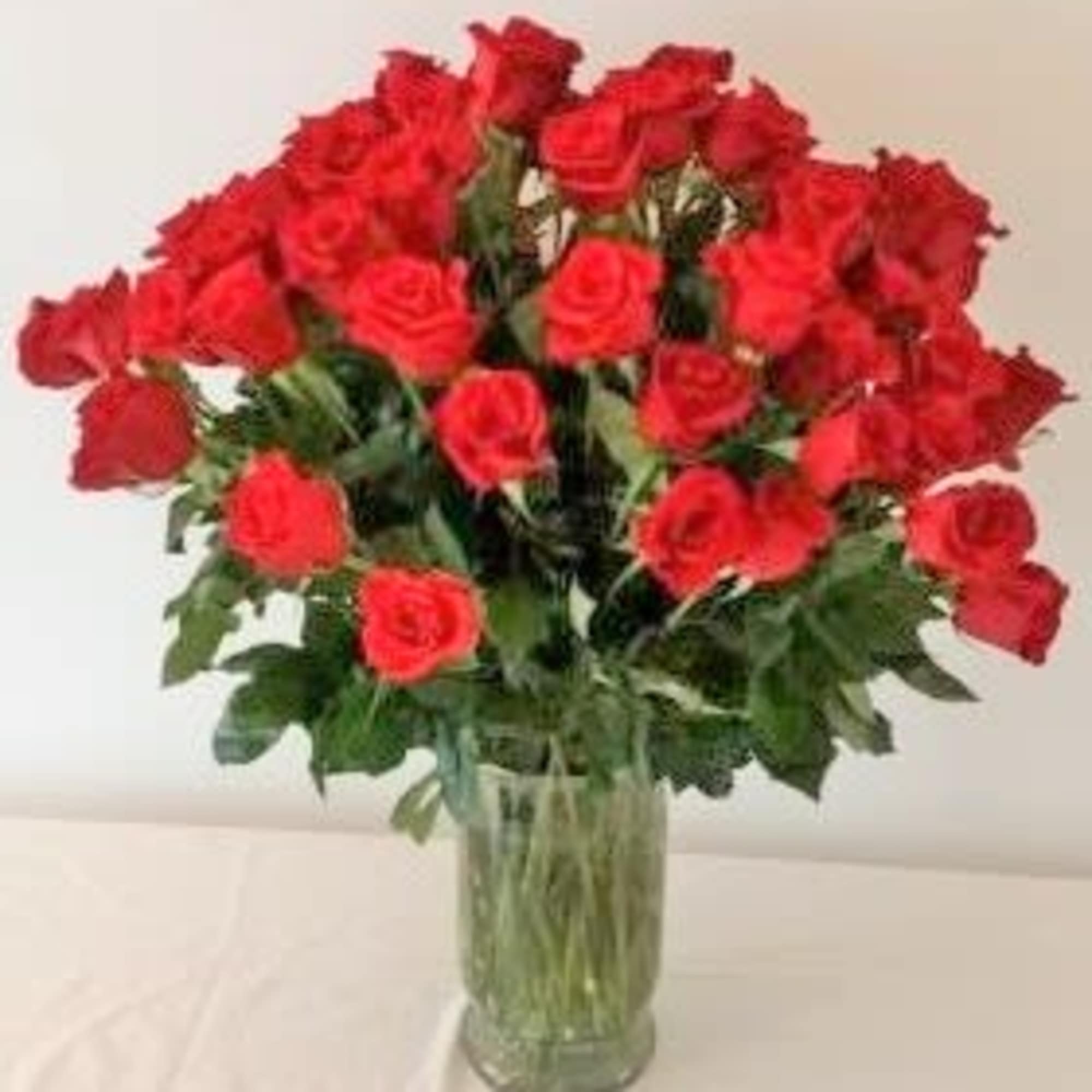 Bouquet of red roses in a clear glass vase