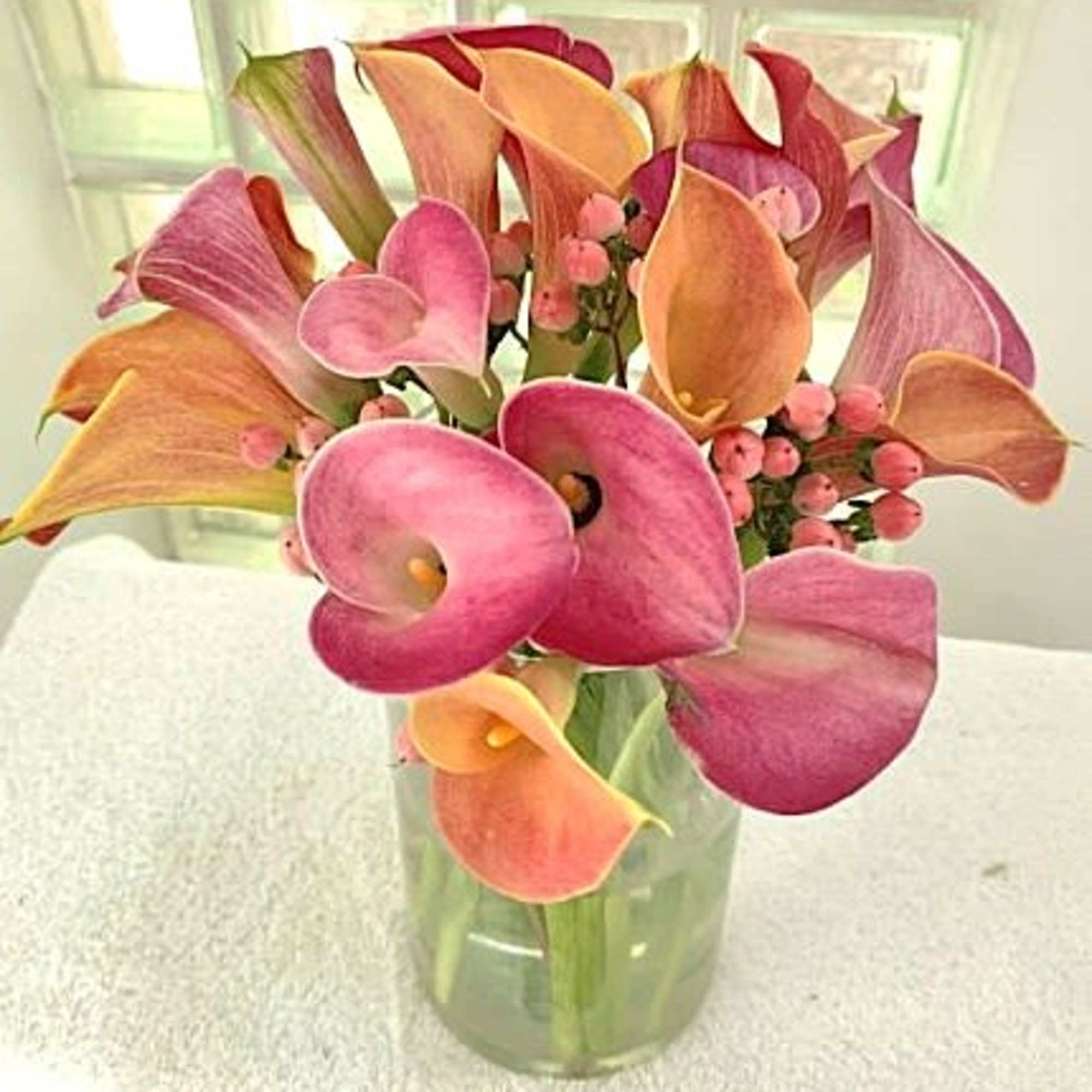 A compact cluster of pink, peach, purple, yellow, white and/or soft coral