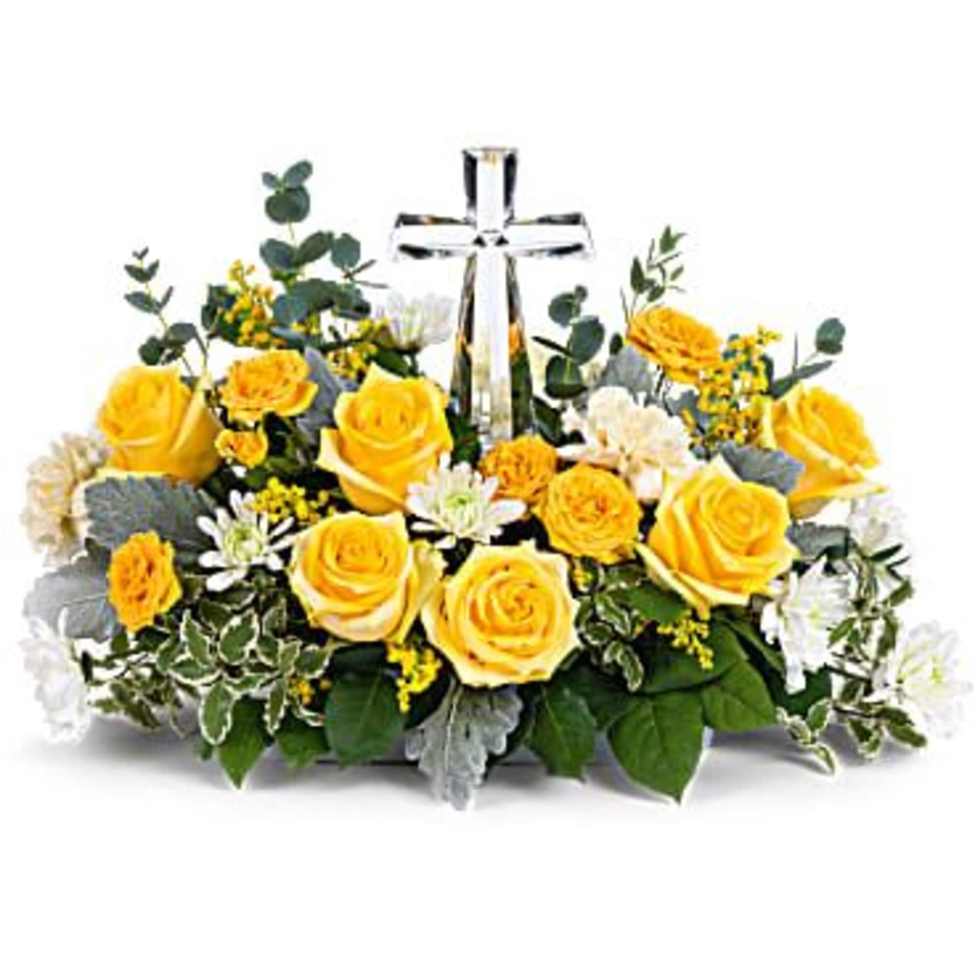 Yellow roses and white flowers arranged around a clear glass cross