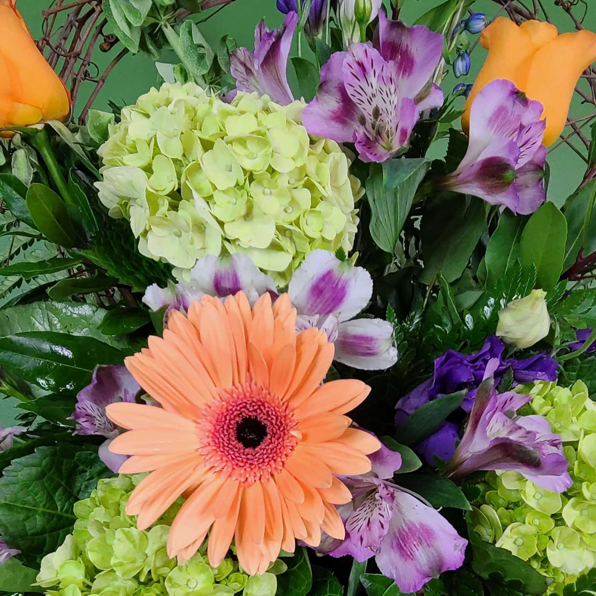 Bouquet with peach gerbera daisies, purple alstroemeria, and pale green hydrangeas