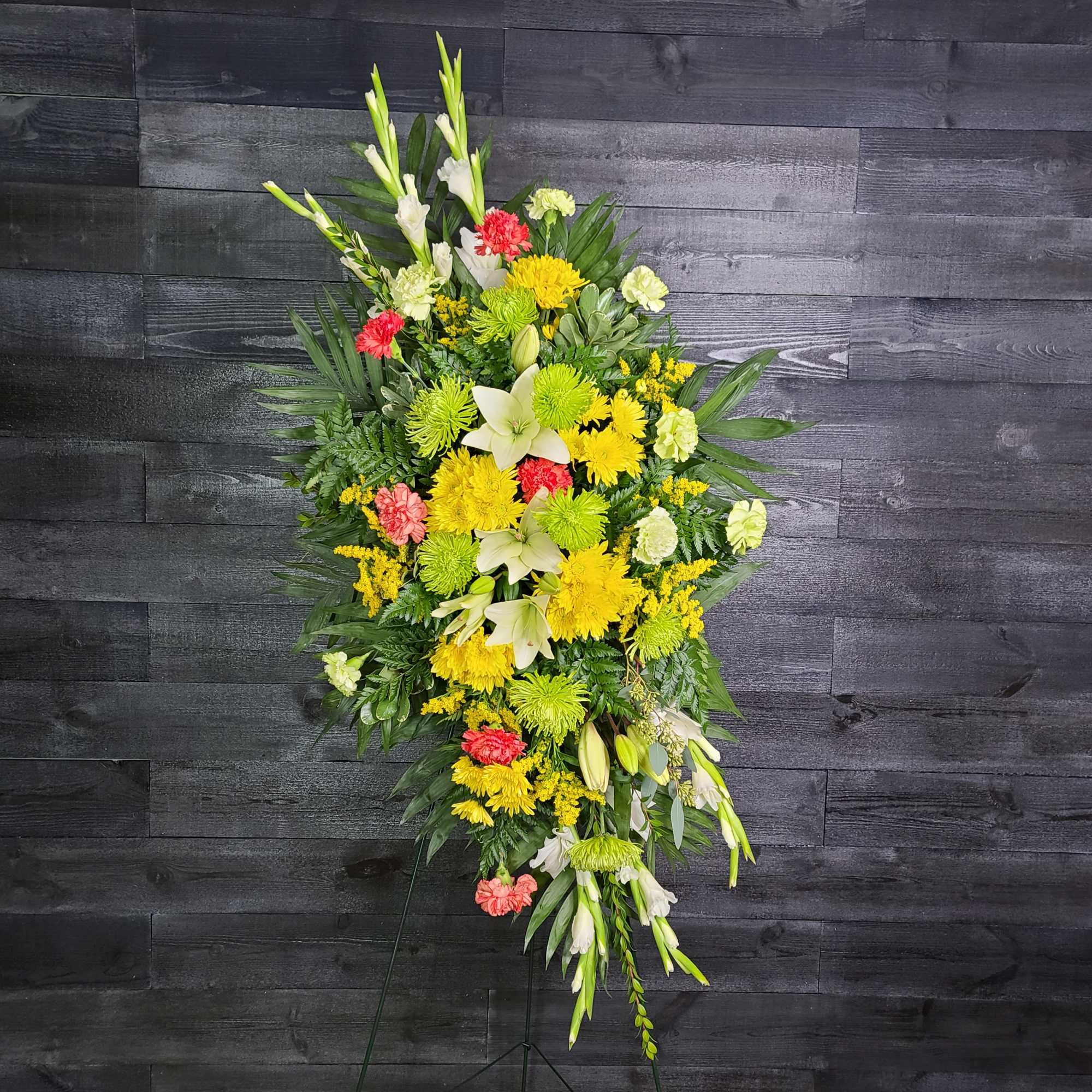 Tall standing floral spray with yellow, white, and coral flowers