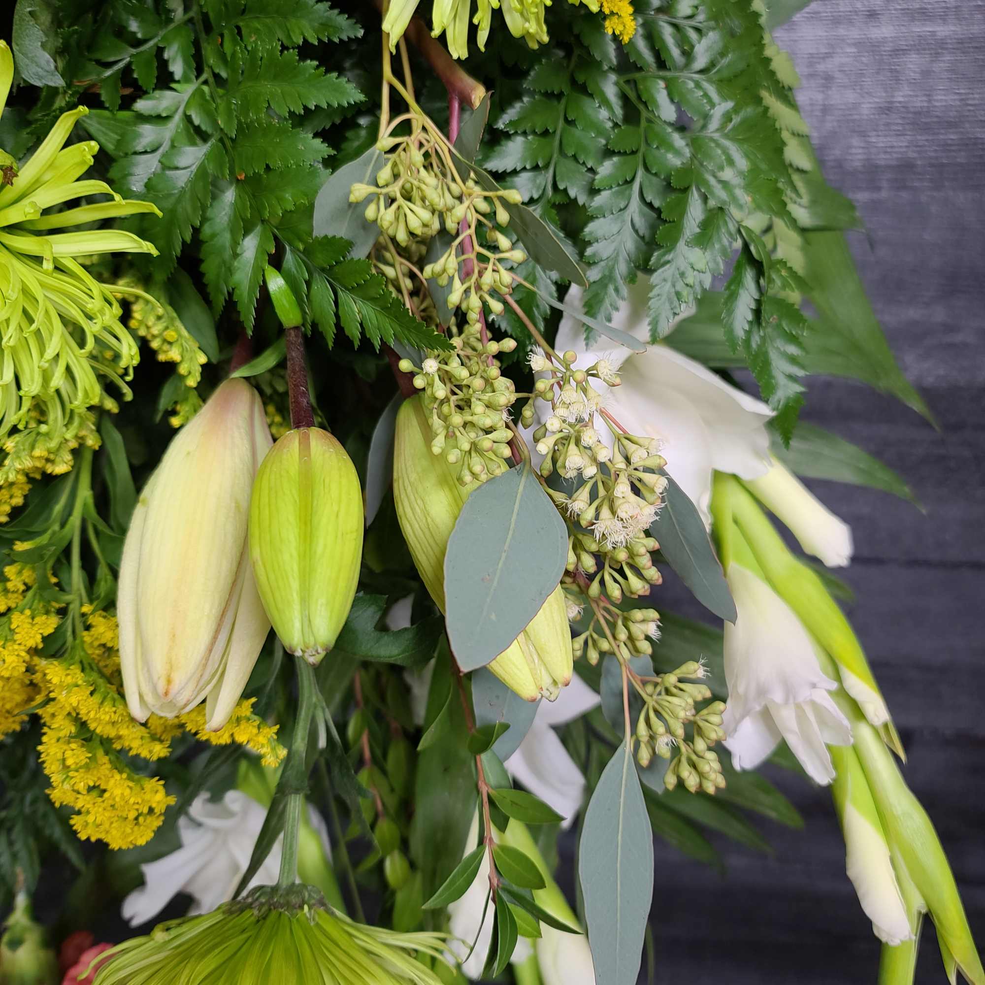 Bouquet with white lilies, green buds, and yellow filler flowers