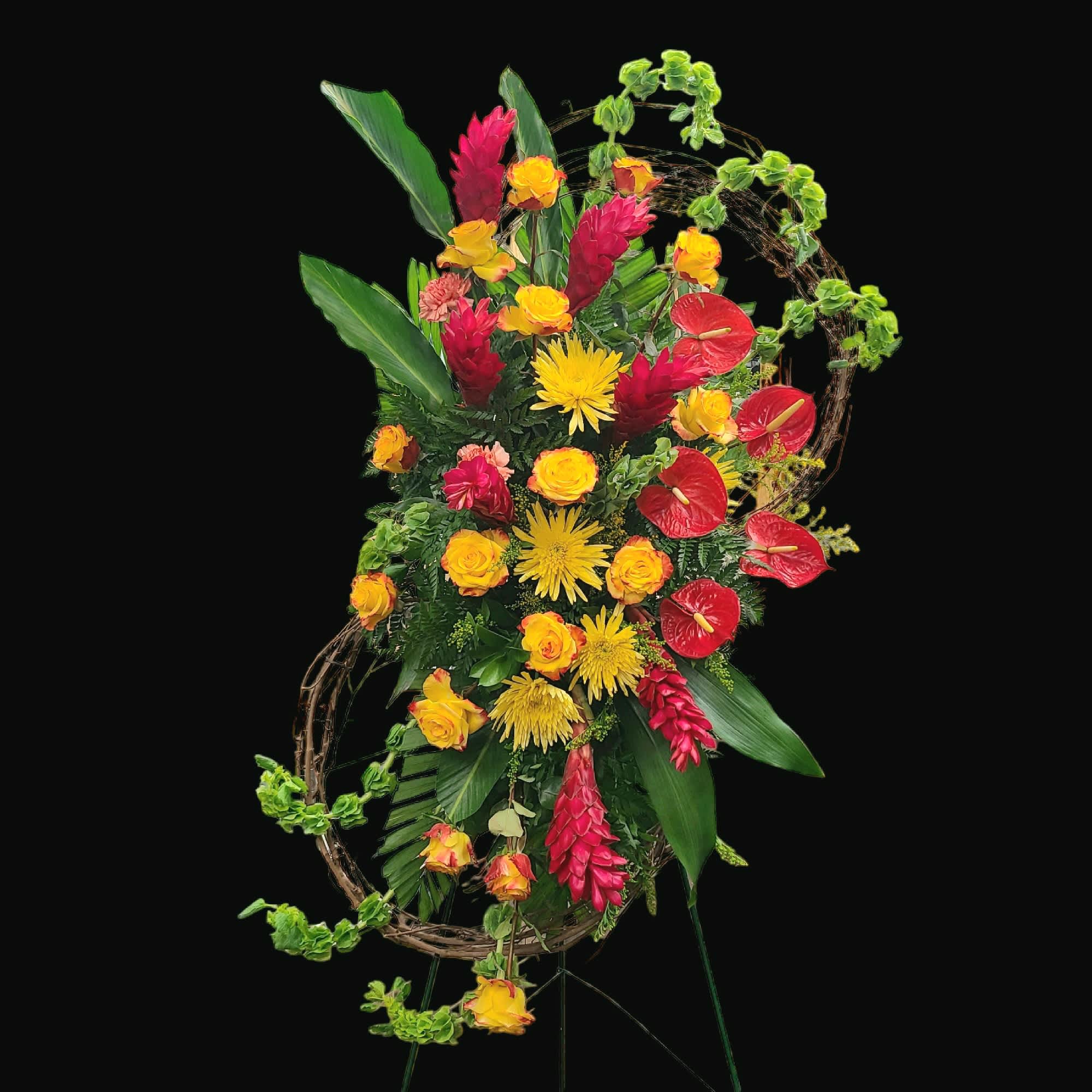 Tropical floral standing arrangement with red, yellow, and orange blooms
