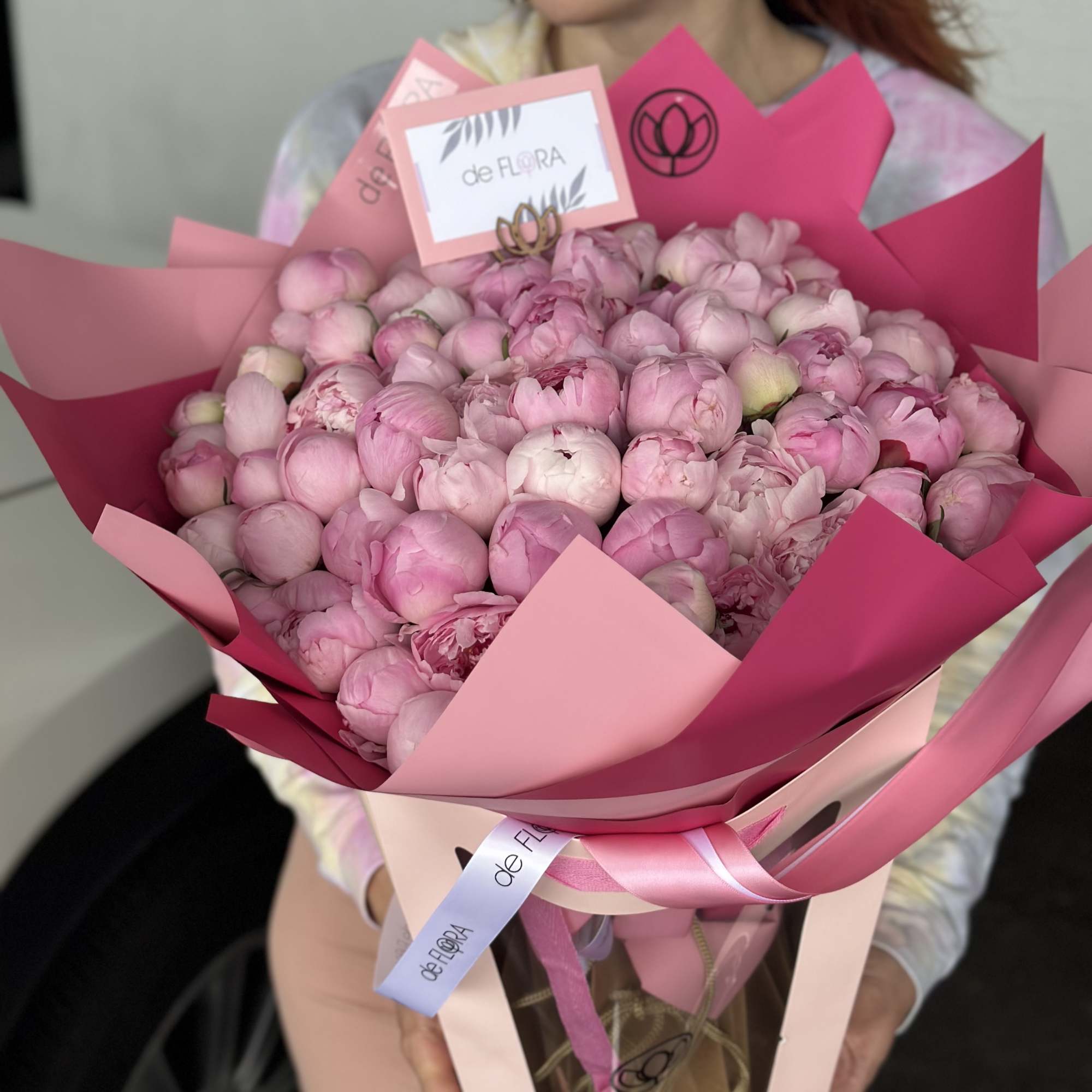 Large pink bouquet of peonies wrapped in pink paper