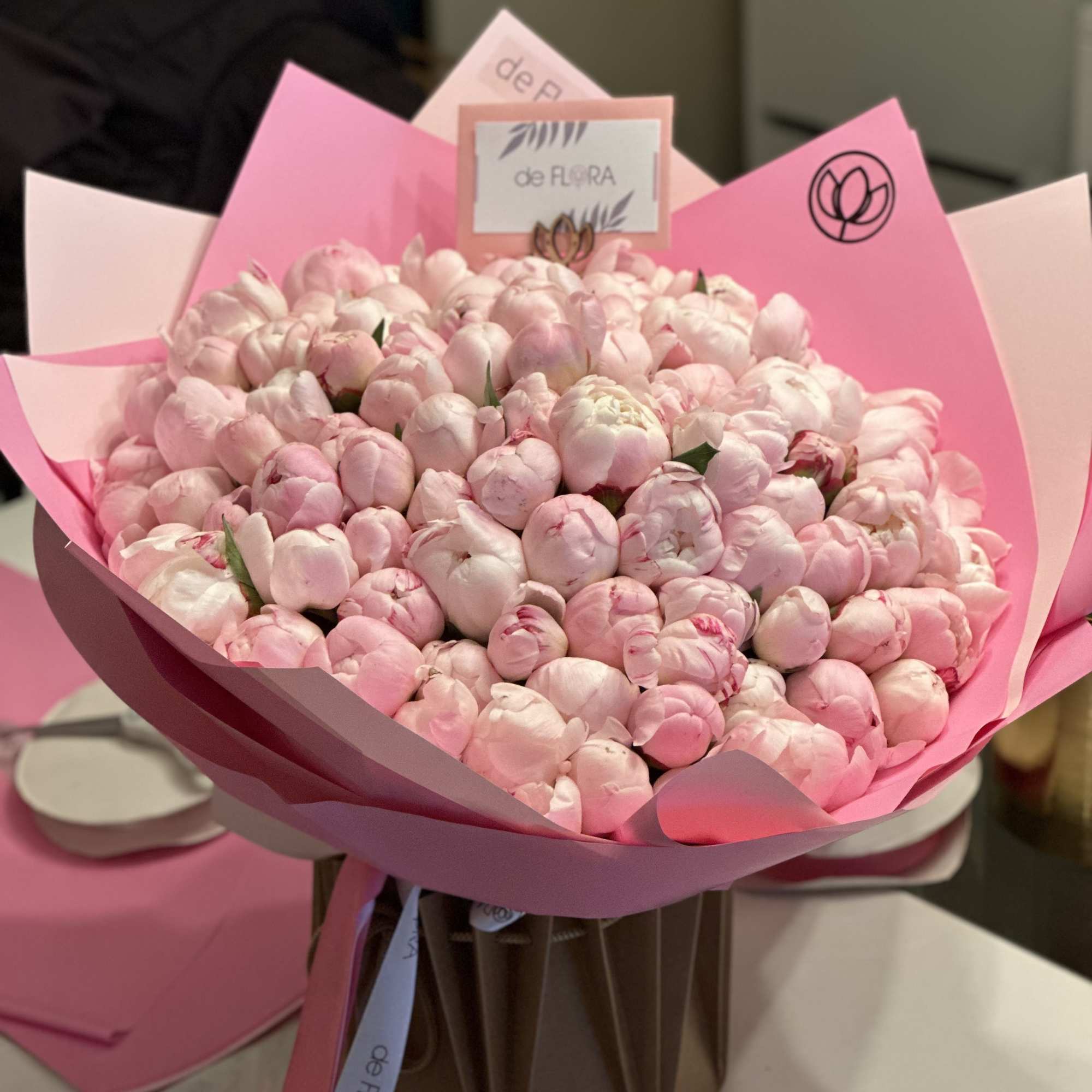 Large bouquet of pale pink peonies wrapped in pink paper, photo 2 of 5