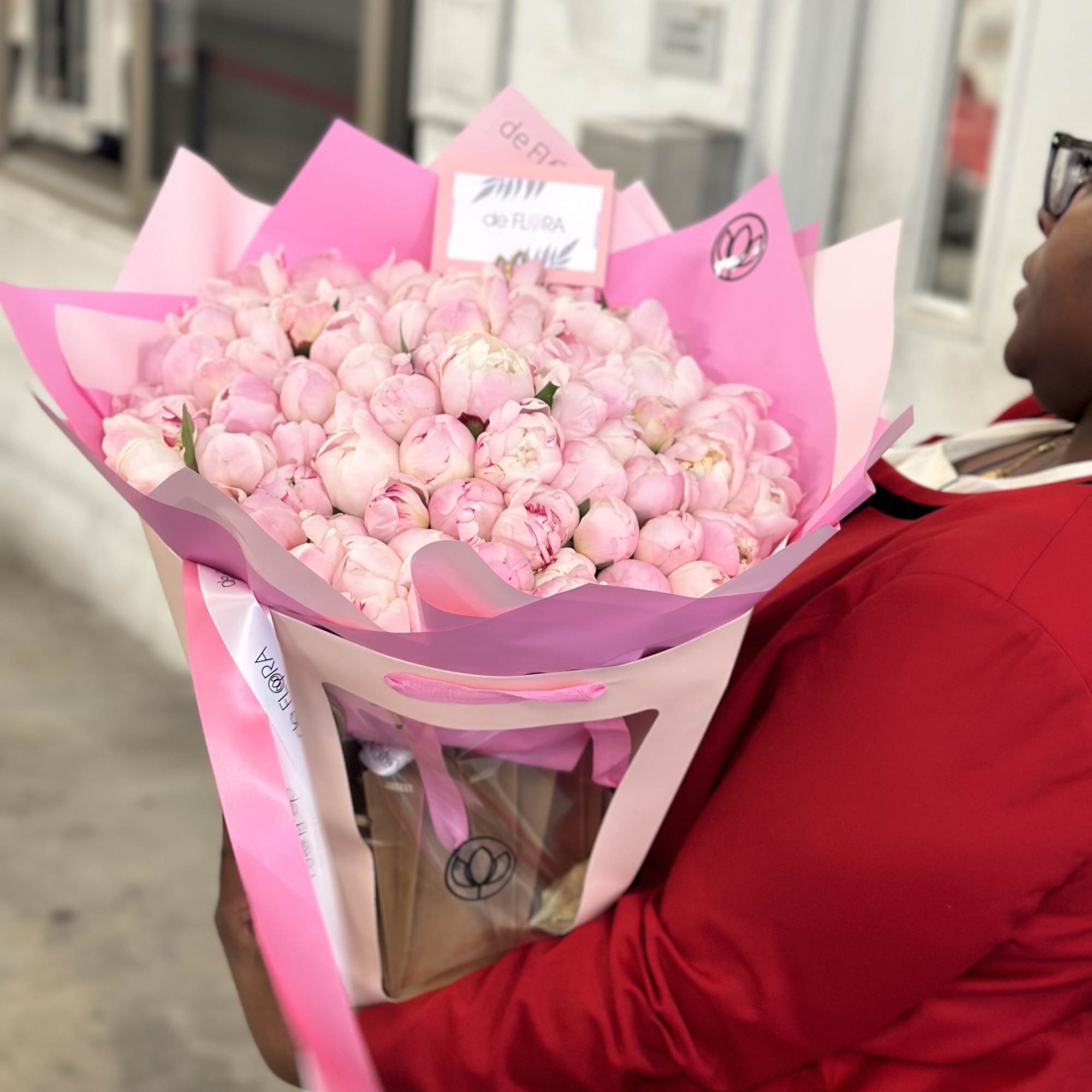 Large bouquet of pale pink peonies wrapped in pink paper, photo 4 of 5