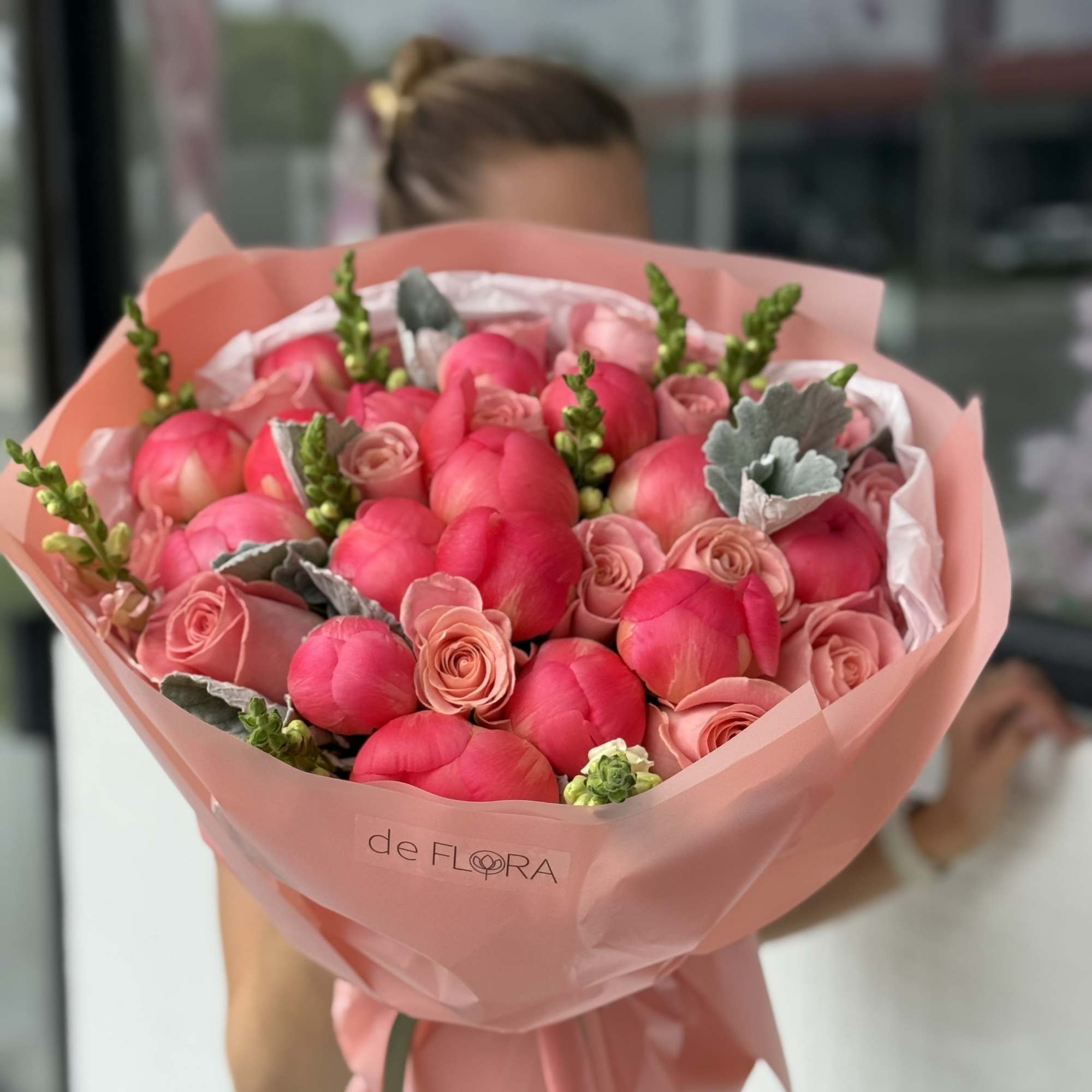 Pink tulip and rose bouquet wrapped in blush paper