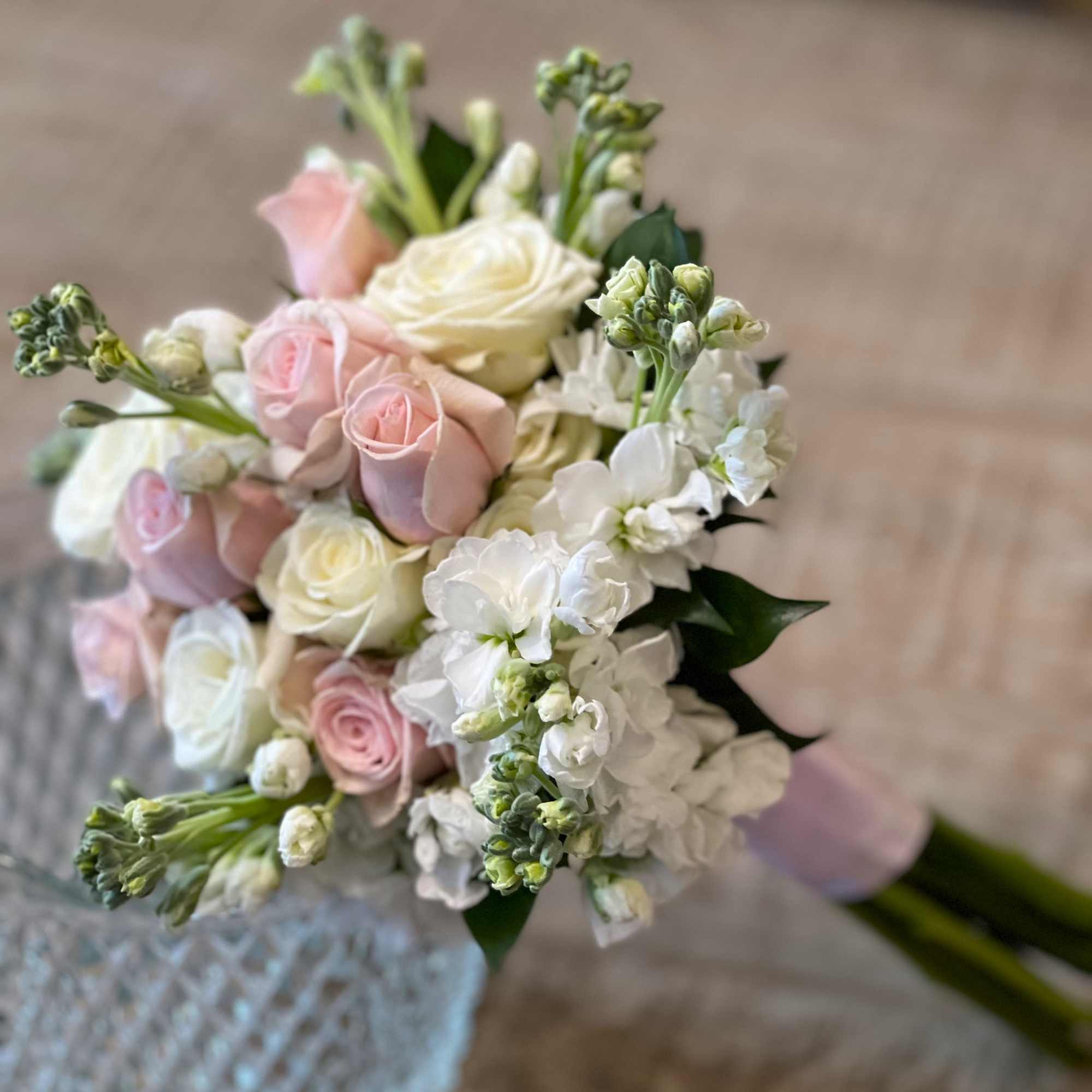 Bouquet of pale pink and white roses with white blossoms