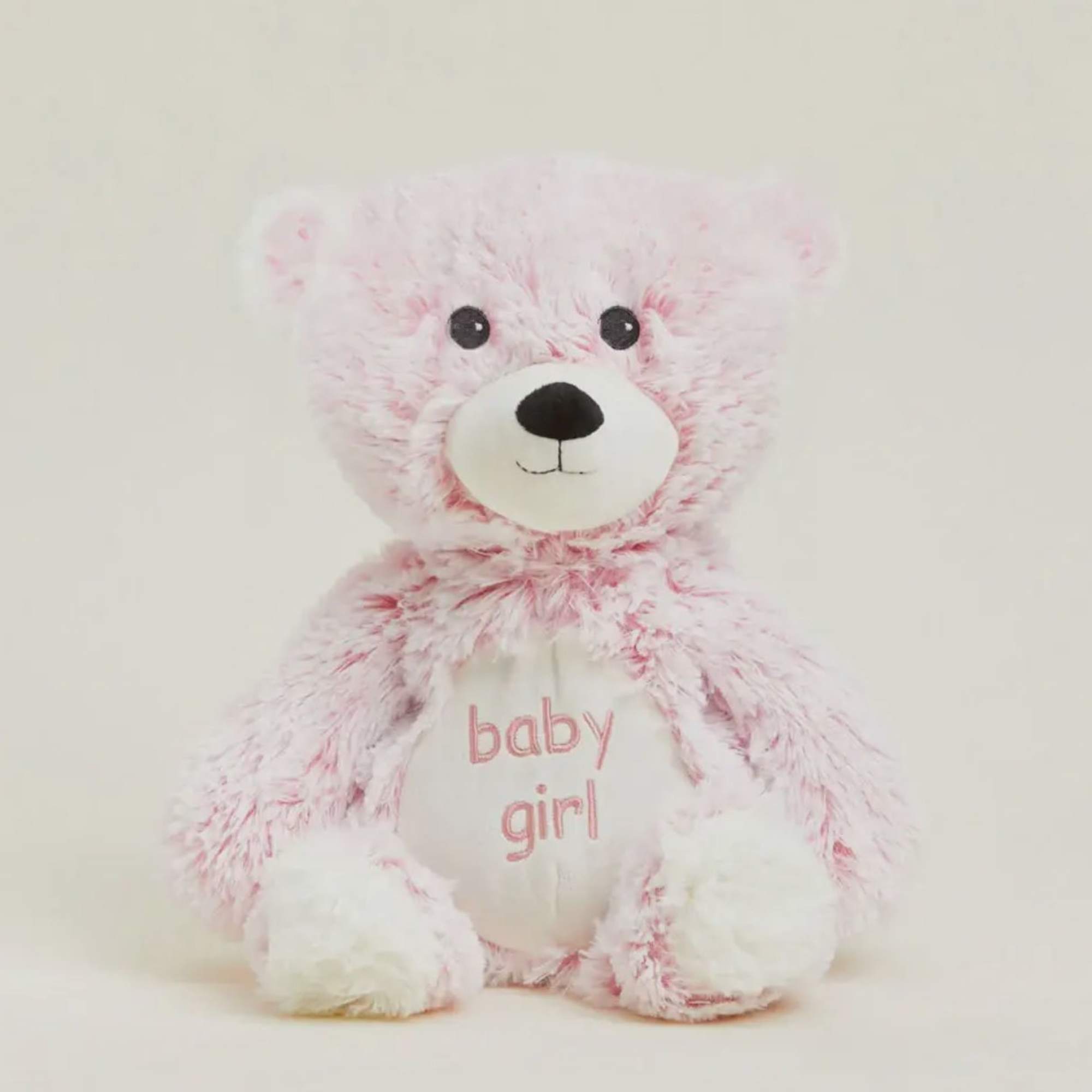 Pink teddy bear with "baby girl" text on its belly