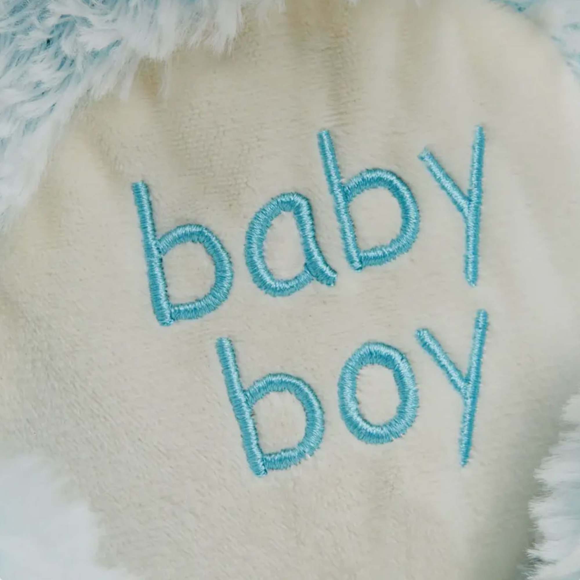 Plush item embroidered with the words baby boy
