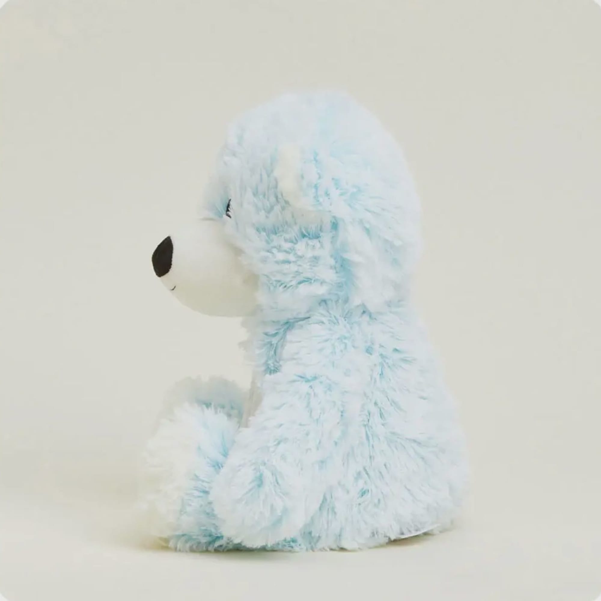 Light blue plush teddy bear sitting in profile