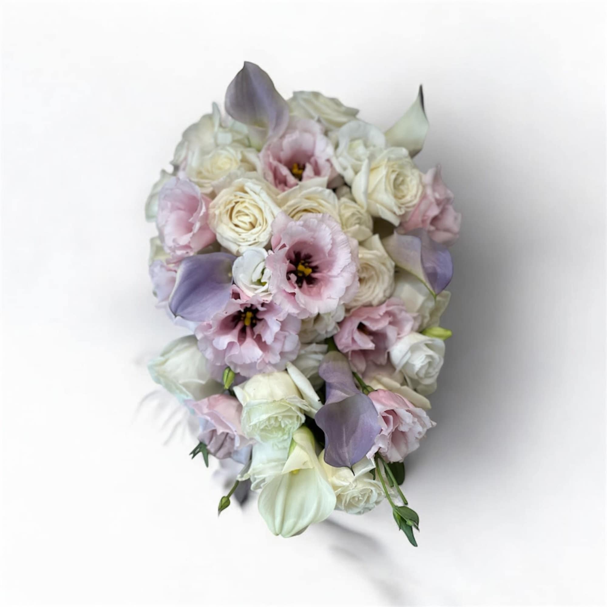 Pastel bouquet of roses, calla lilies, and pink blooms
