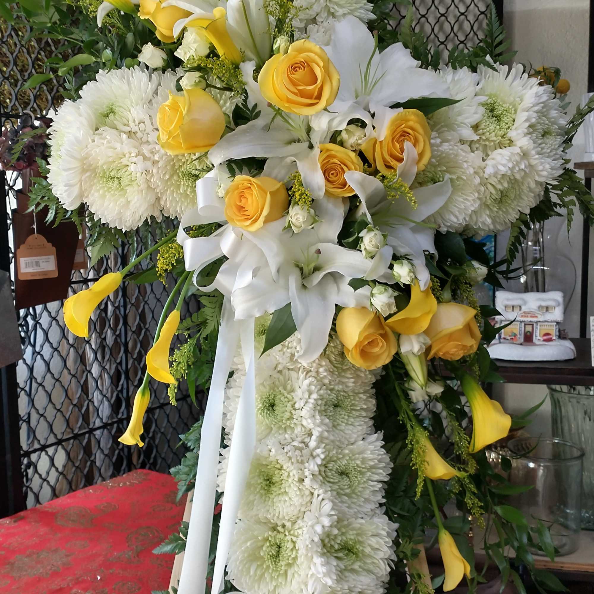 Standing floral spray with white chrysanthemums, yellow roses, and white lilies