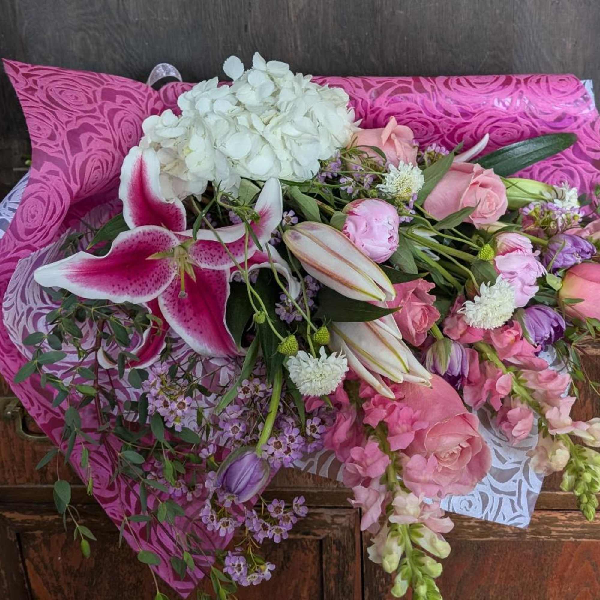 Pink and white mixed bouquet wrapped in bright magenta paper