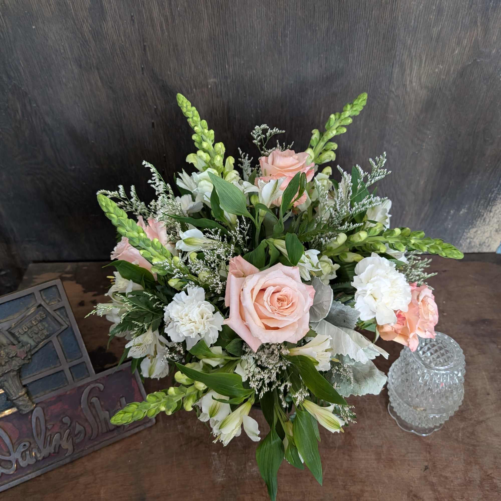 Bouquet of pale pink roses and white flowers on a table