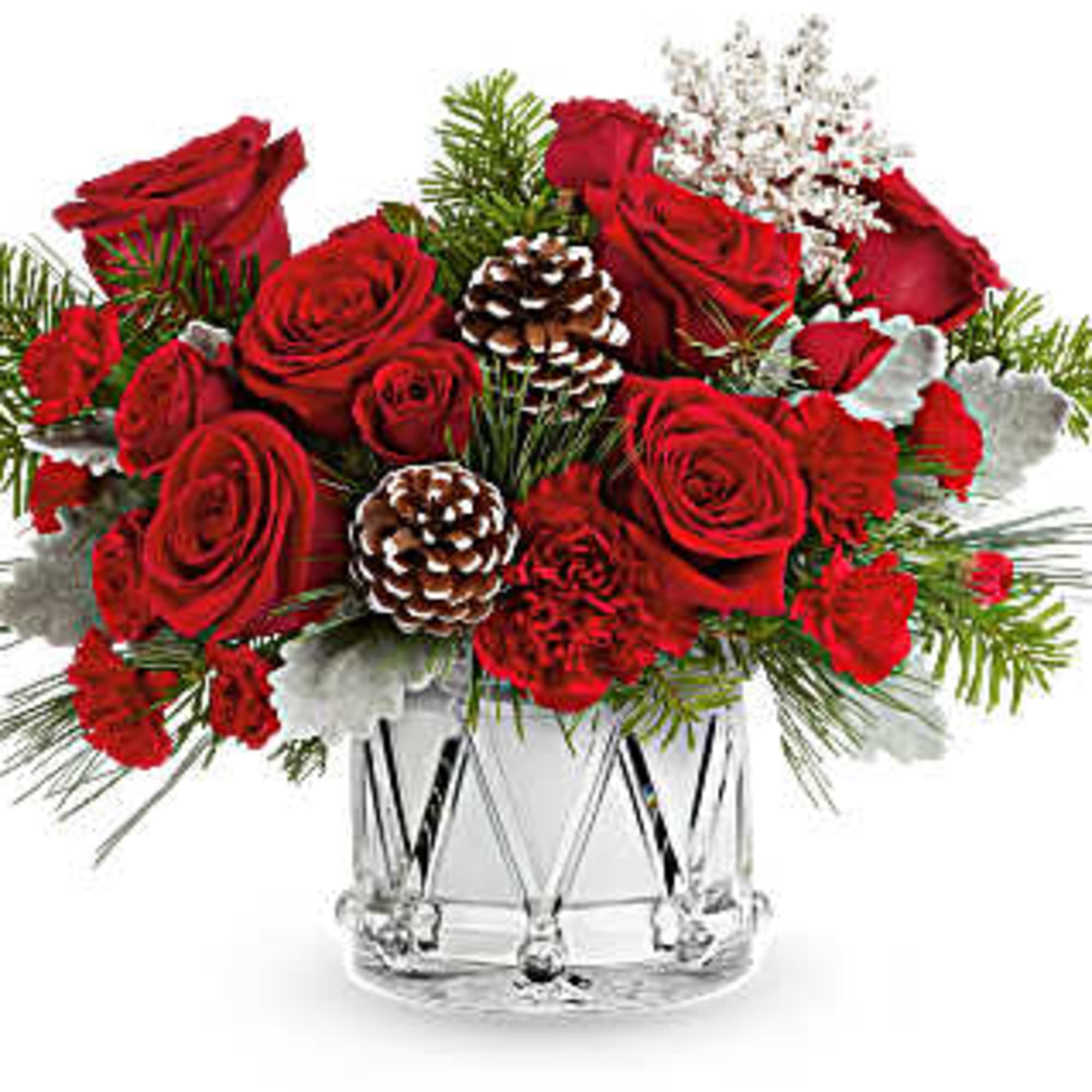Red roses arranged in a clear glass vase with pinecones and evergreen accents