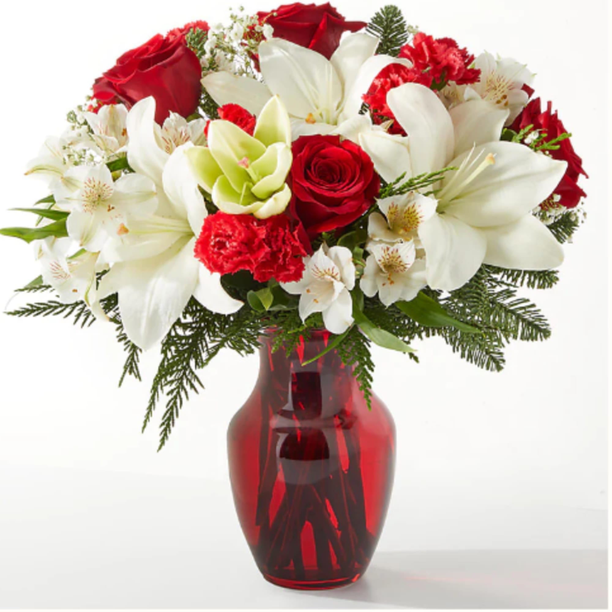 Red roses and white lilies in a red glass vase
