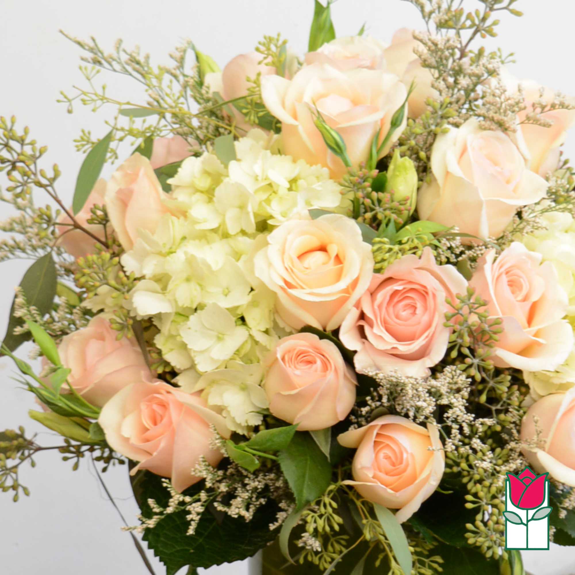 Bouquet of peach roses and pale hydrangeas with greenery