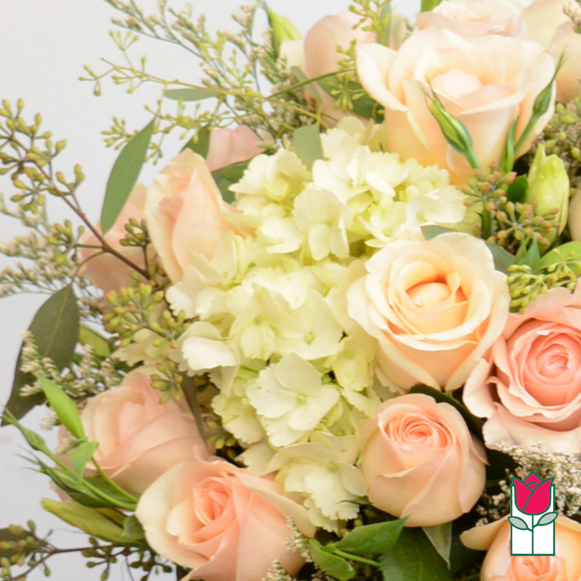 Peach roses with pale hydrangeas in a mixed bouquet