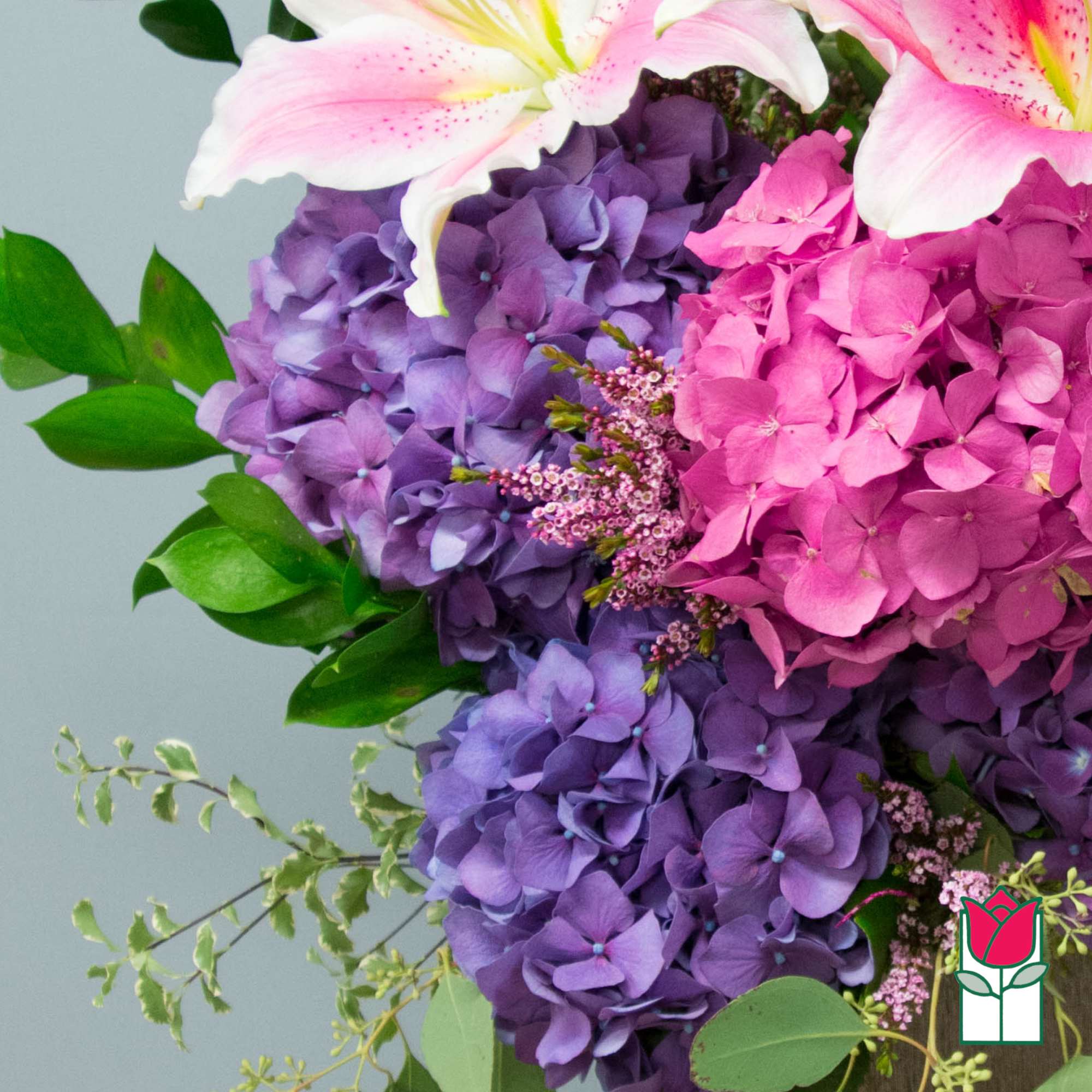 Pink and purple hydrangea bouquet with white lilies